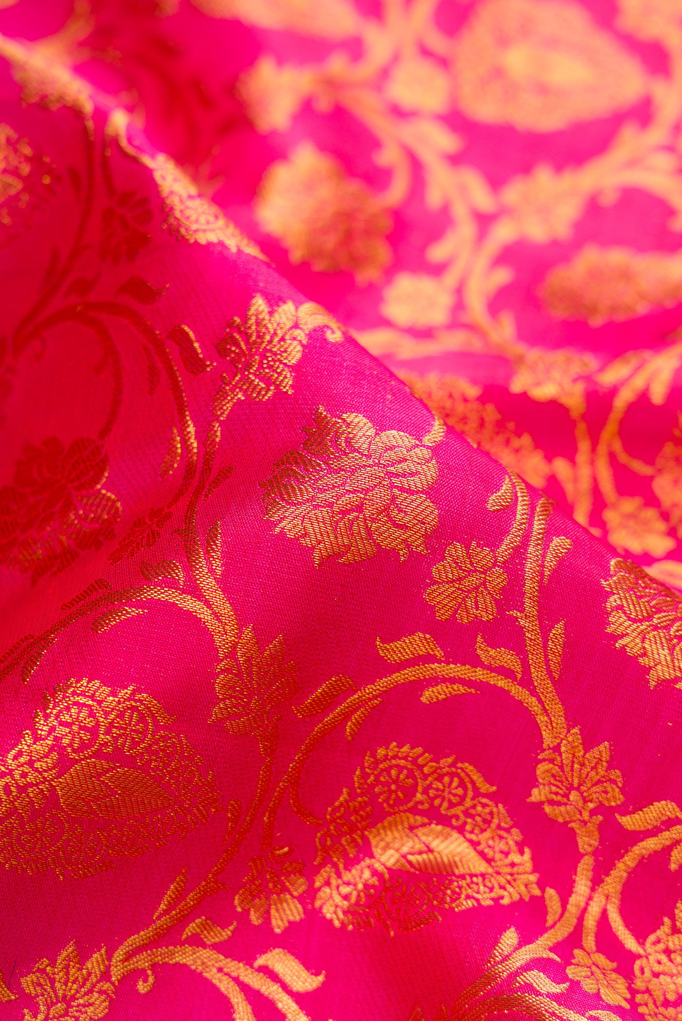 Close up of Pink Dual Tone Kanjivaram Silk Saree with Zari Brocade on the body and Zari Border.  displaying folds