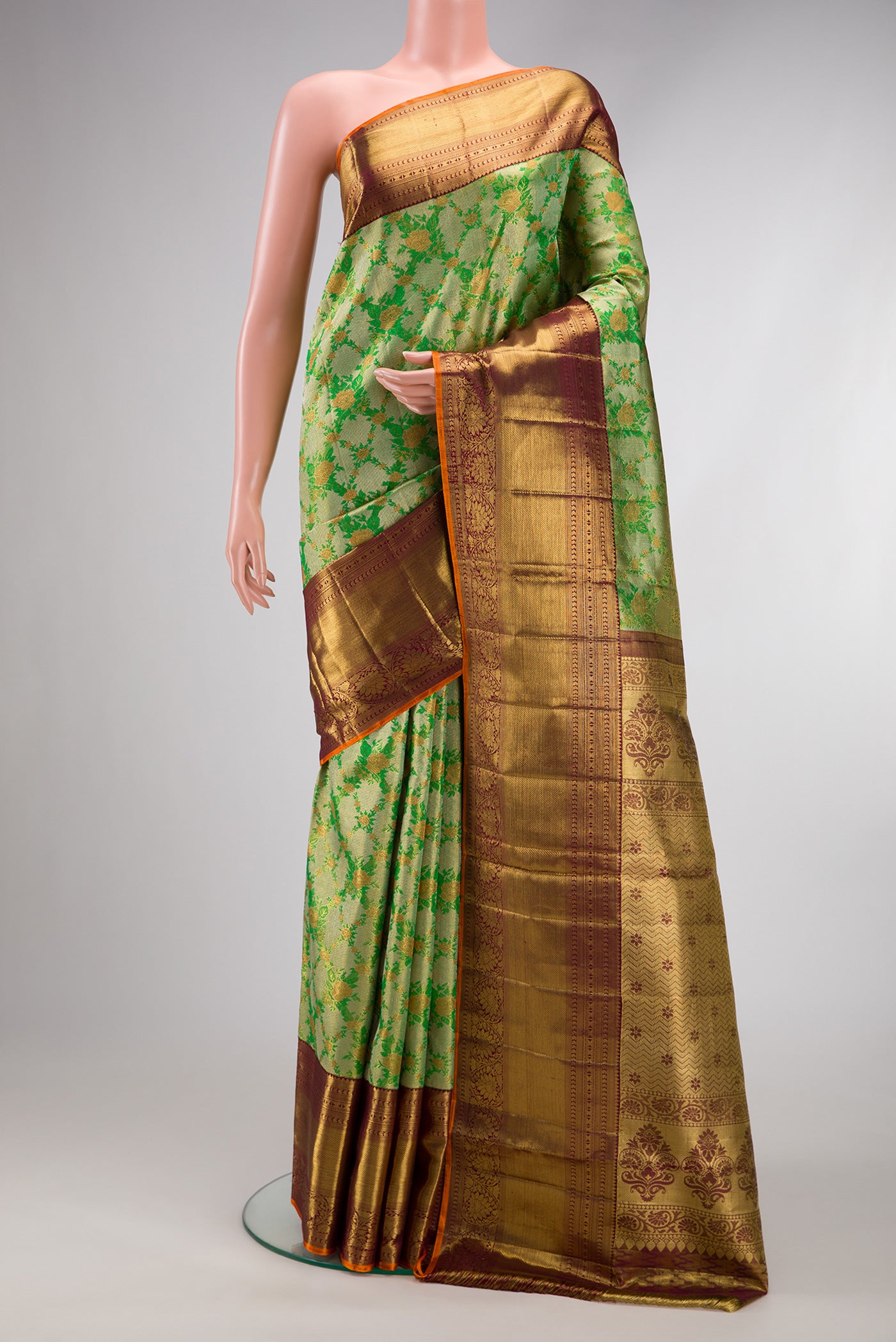 Green Dual Tone Kanjivaram Tissue Silk Saree with Zari Brocade on the body and Zari Border.  displayed on a mannequin
