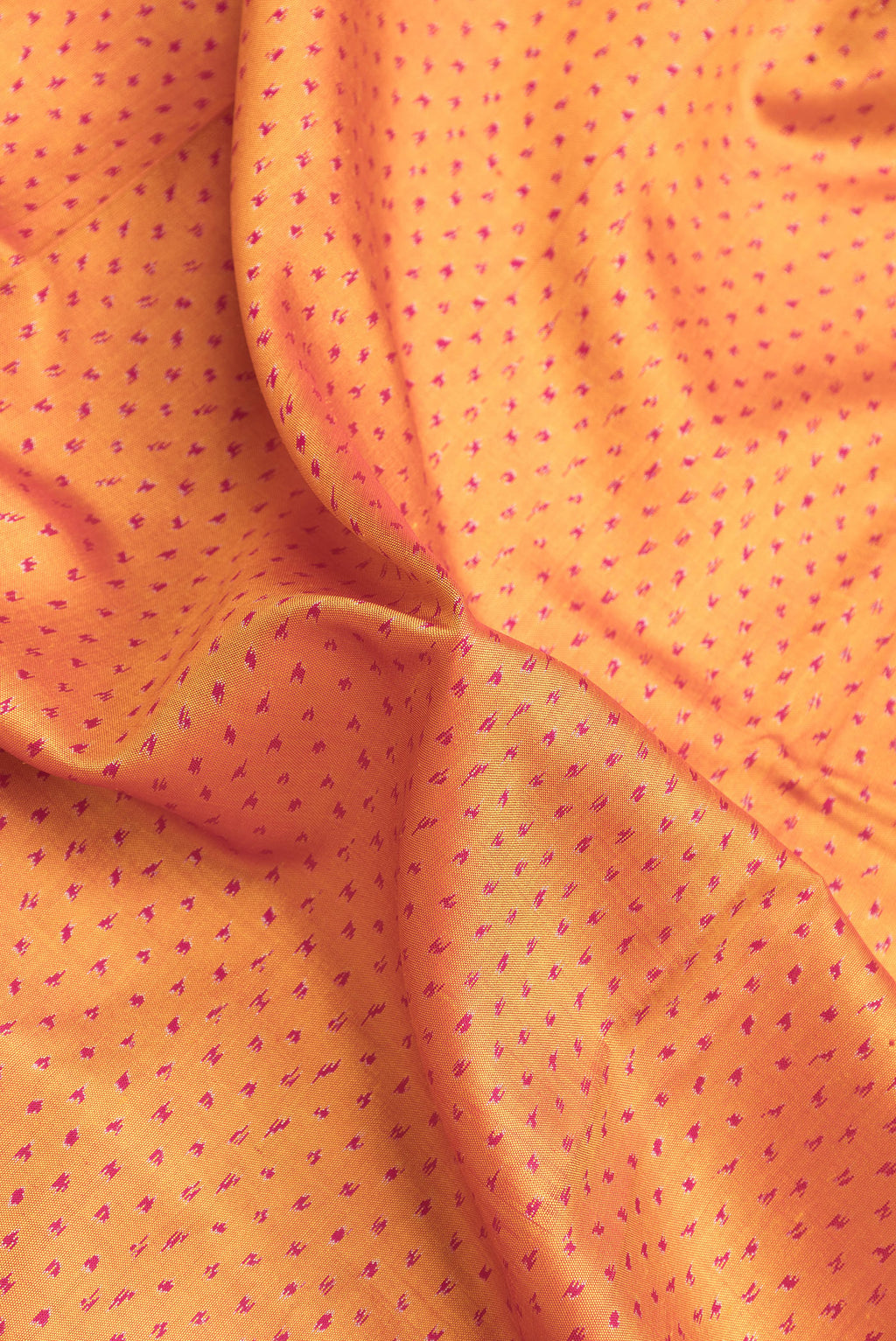 Close up of Mustard Dual Tone Double Ikat Saree with Ikat Print on the body and Paithani Border.  displaying folds