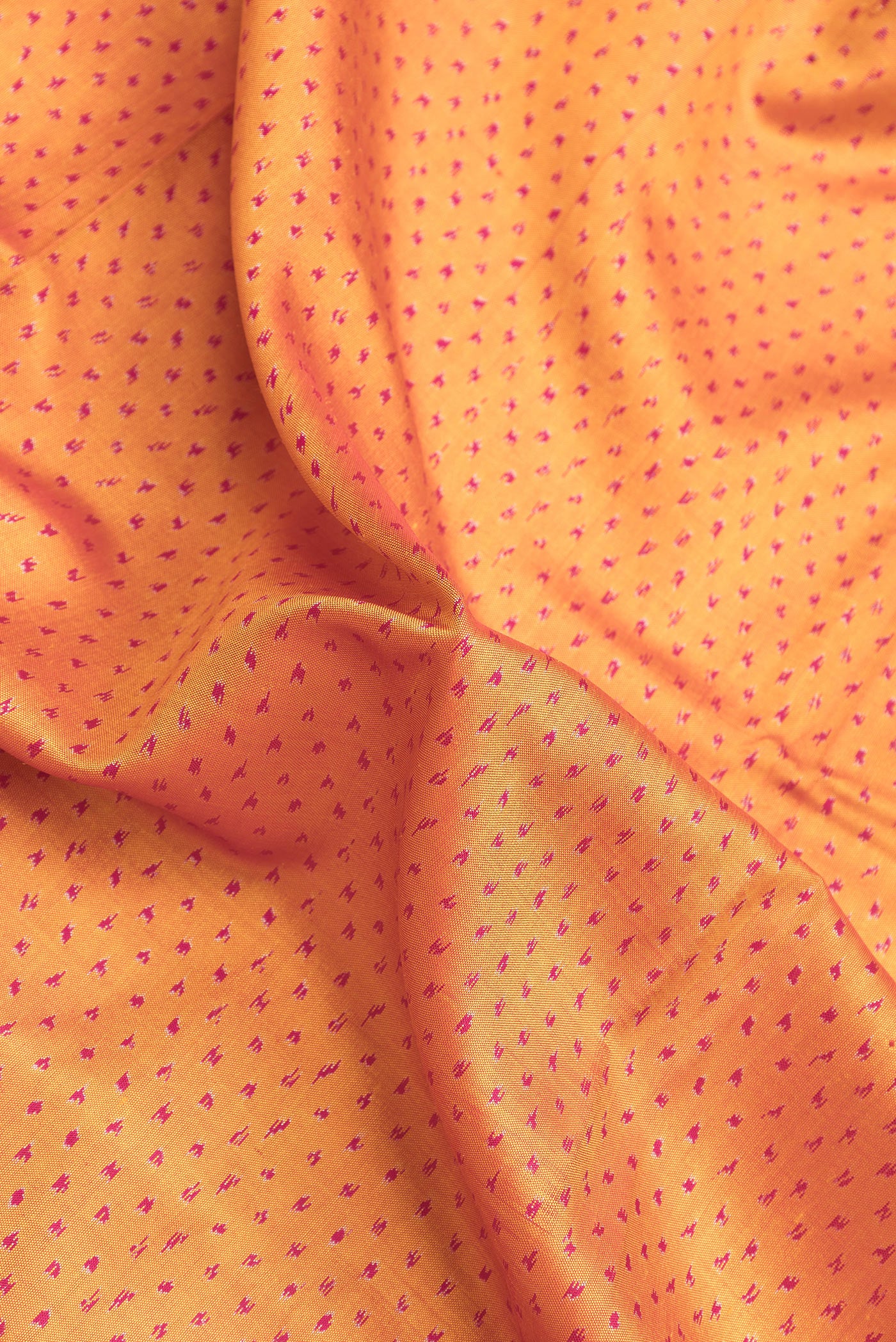 Close up of Mustard Dual Tone Double Ikat Saree with Ikat Print on the body and Paithani Border.  displaying folds