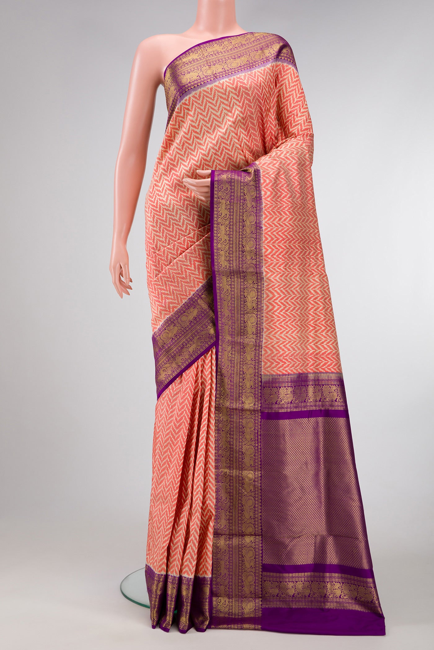 Orange Dual Tone Double Ikat Saree with Ikat Print on the body and Ikat Border.  displayed on a mannequin