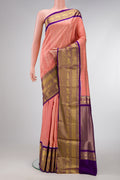 Off White and Orange Color Double Ikat Saree with Ikat Print on the body and Zari Border.  displayed on a mannequin