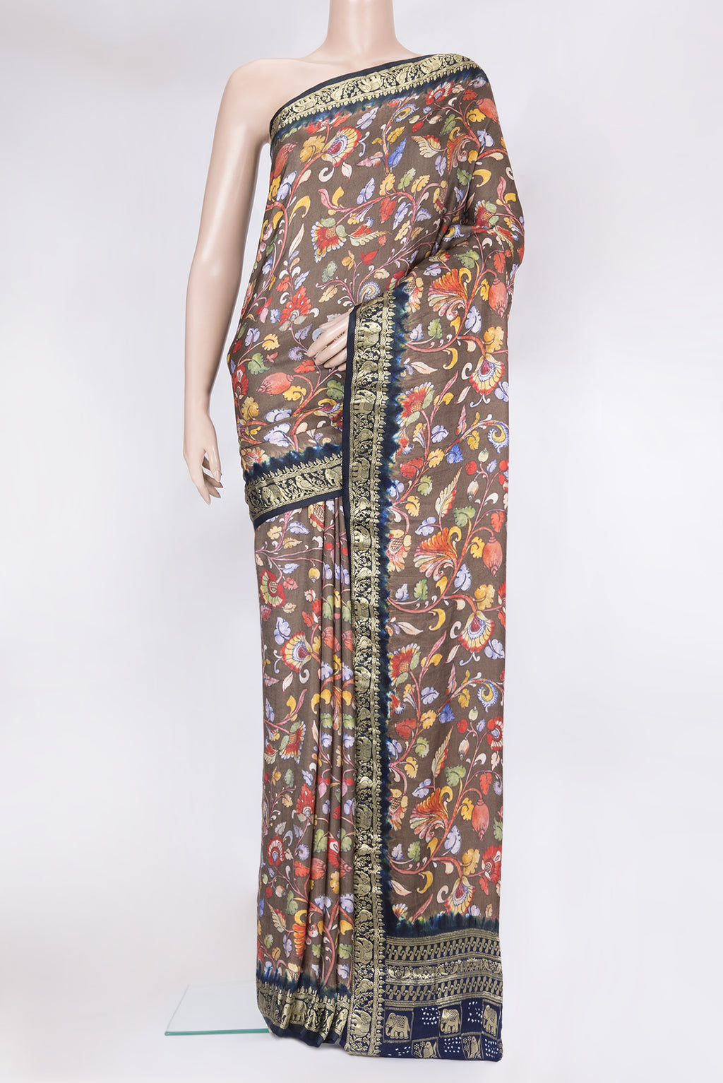 Grey kalamkari Saree with Printed design on the body and Zari Border.  displayed on a mannequin