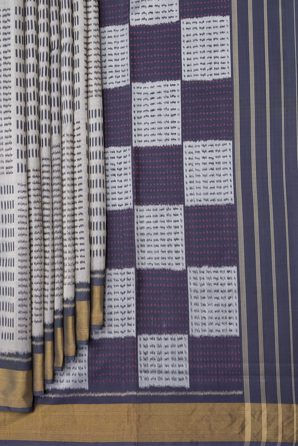 Pleats and pallu of Grey Dual Tone Rajkot Patola Silk Saree with Ikat Print on the body and Zari Border. 