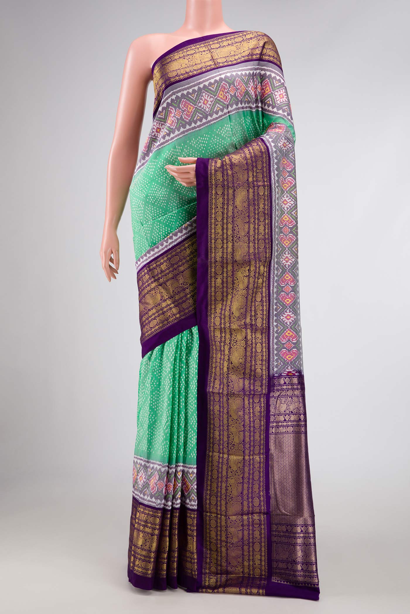 Sea Green Pochampally Silk Saree with Pure Ikat on the body and Zari Border displayed on a mannequin