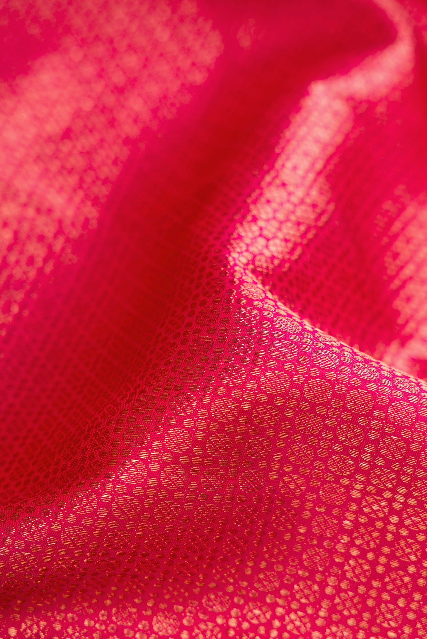 Close up of Pink Dual Tone Kanchipuram Silk Saree with Zari Brocade on the body and Zari Border.  displaying folds