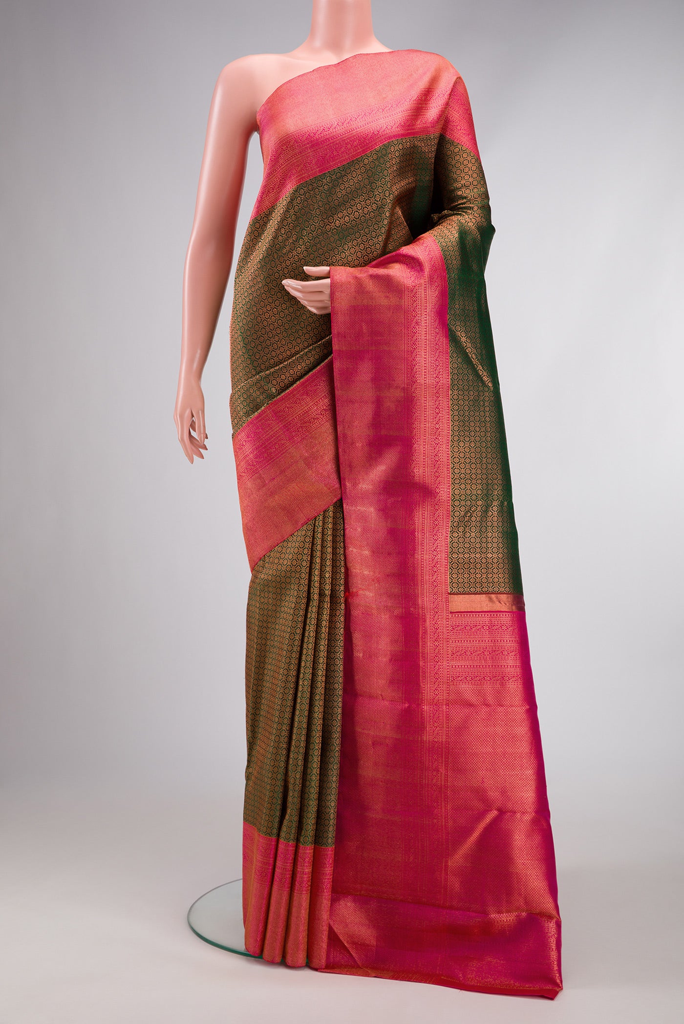 Bottle Green Dual Tone Kanchipuram Silk Saree with Zari Brocade on the body and Fancy Border.  displayed on a mannequin