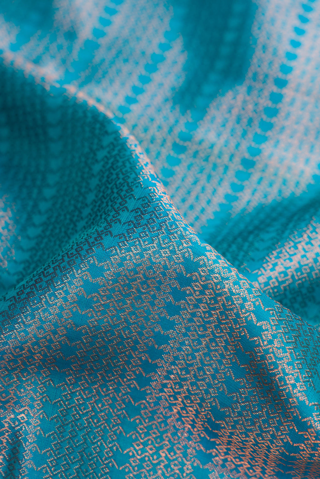 Close up of Peacock Blue Dual Tone Kanjivaram Silk Saree with Zari Brocade on the body and Fancy Border.  displaying folds