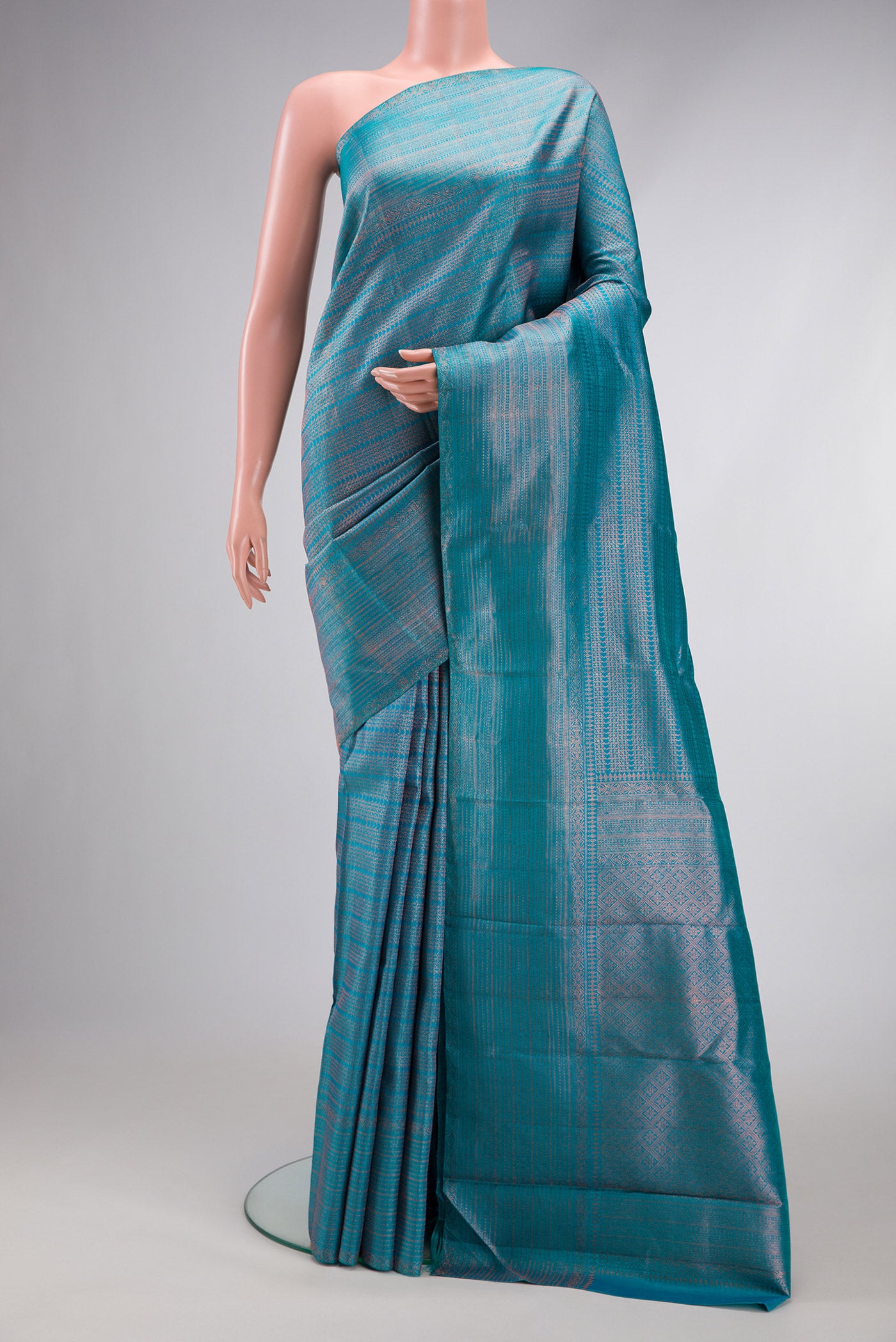 Peacock Blue Dual Tone Kanjivaram Silk Saree with Zari Brocade on the body and Fancy Border.  displayed on a mannequin