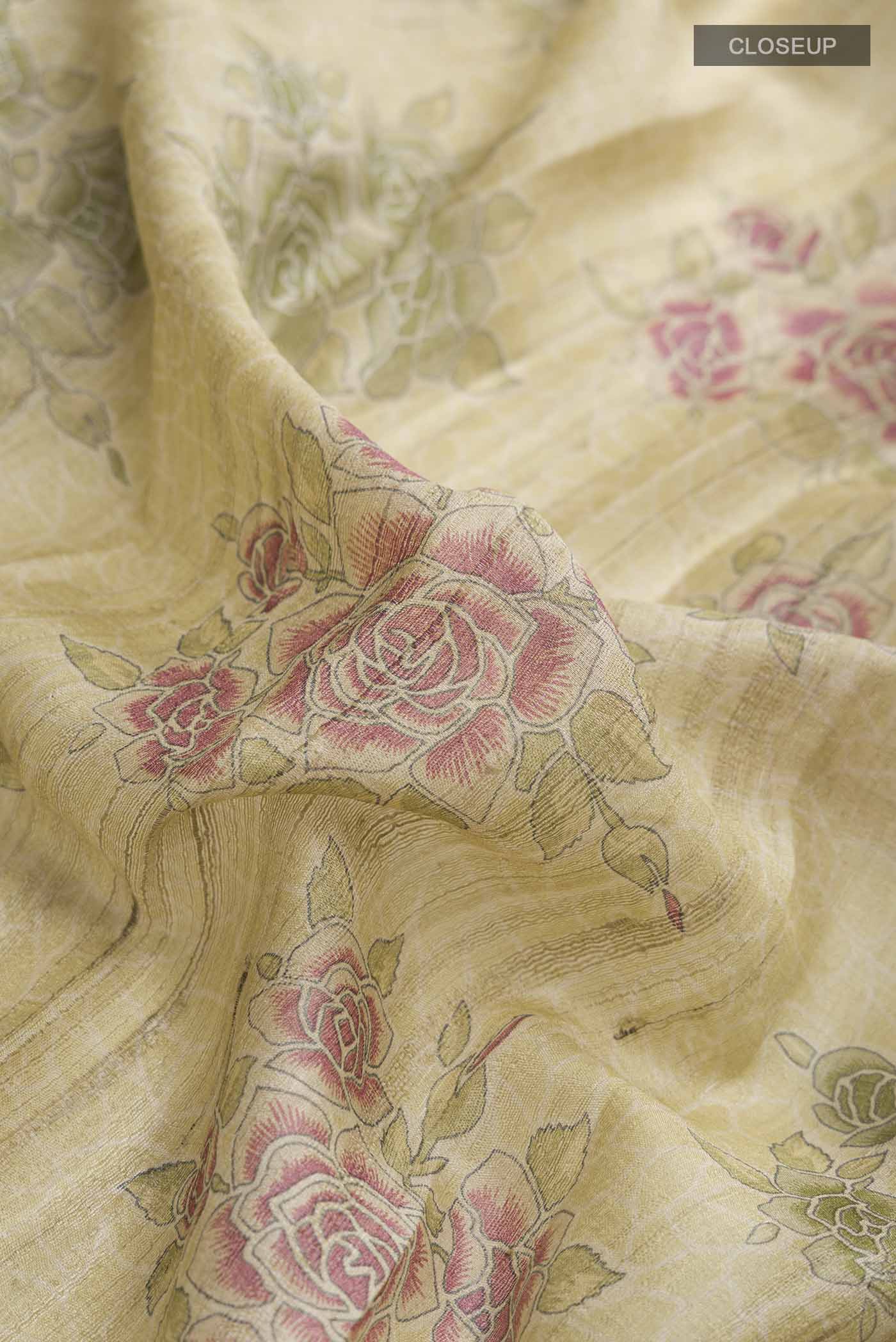 Close up of Beige Tussar Silk Saree with Printed design on the body and Zari Border displaying folds