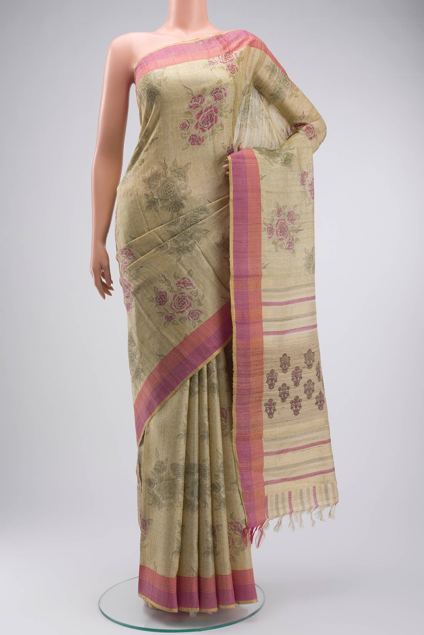 Beige Tussar Silk Saree with Printed design on the body and Zari Border displayed on a mannequin