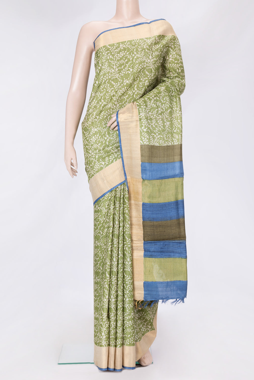Green Dual Tone Tussar Silk Saree with Printed design on the body and Zari Border.  displayed on a mannequin