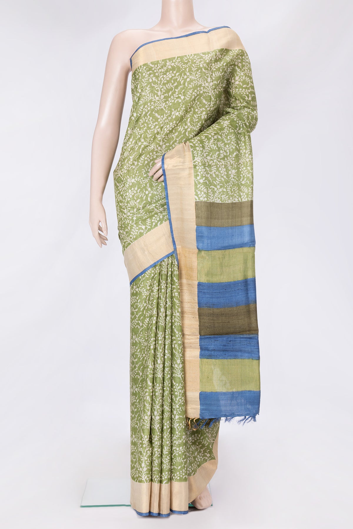 Green Dual Tone Tussar Silk Saree with Printed design on the body and Zari Border.  displayed on a mannequin