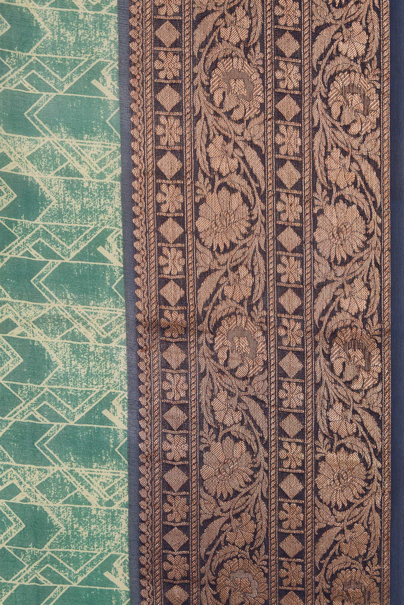 Border image of Green Dual Tone Organza Silk Saree with Printed design on the body and Zari Border. 