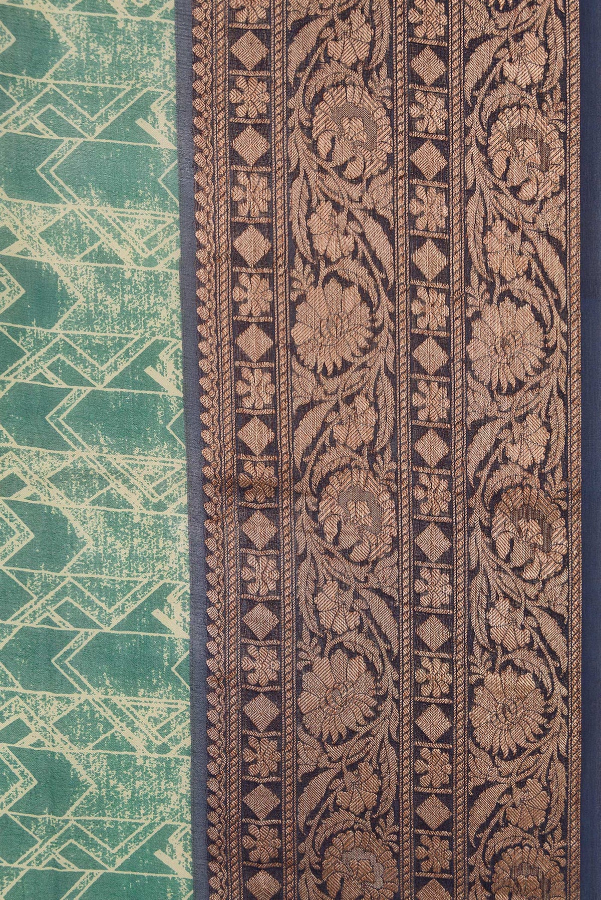 Border image of Green Dual Tone Organza Silk Saree with Printed design on the body and Zari Border. 