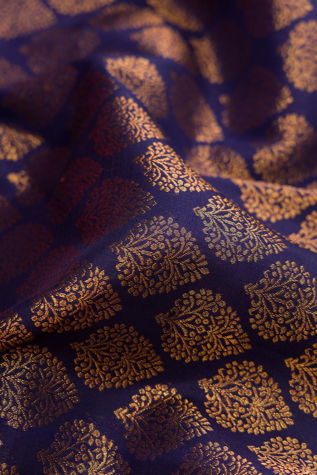 Close up of Navy Blue Dual Tone Kanchipuram Silk Saree with Zari Brocade on the body and Zari Border.  displaying folds