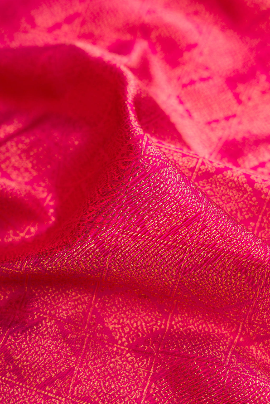 Close up of Pink Dual Tone Kanjivaram Silk Saree with Zari Brocade on the body and Zari Border.  displaying folds