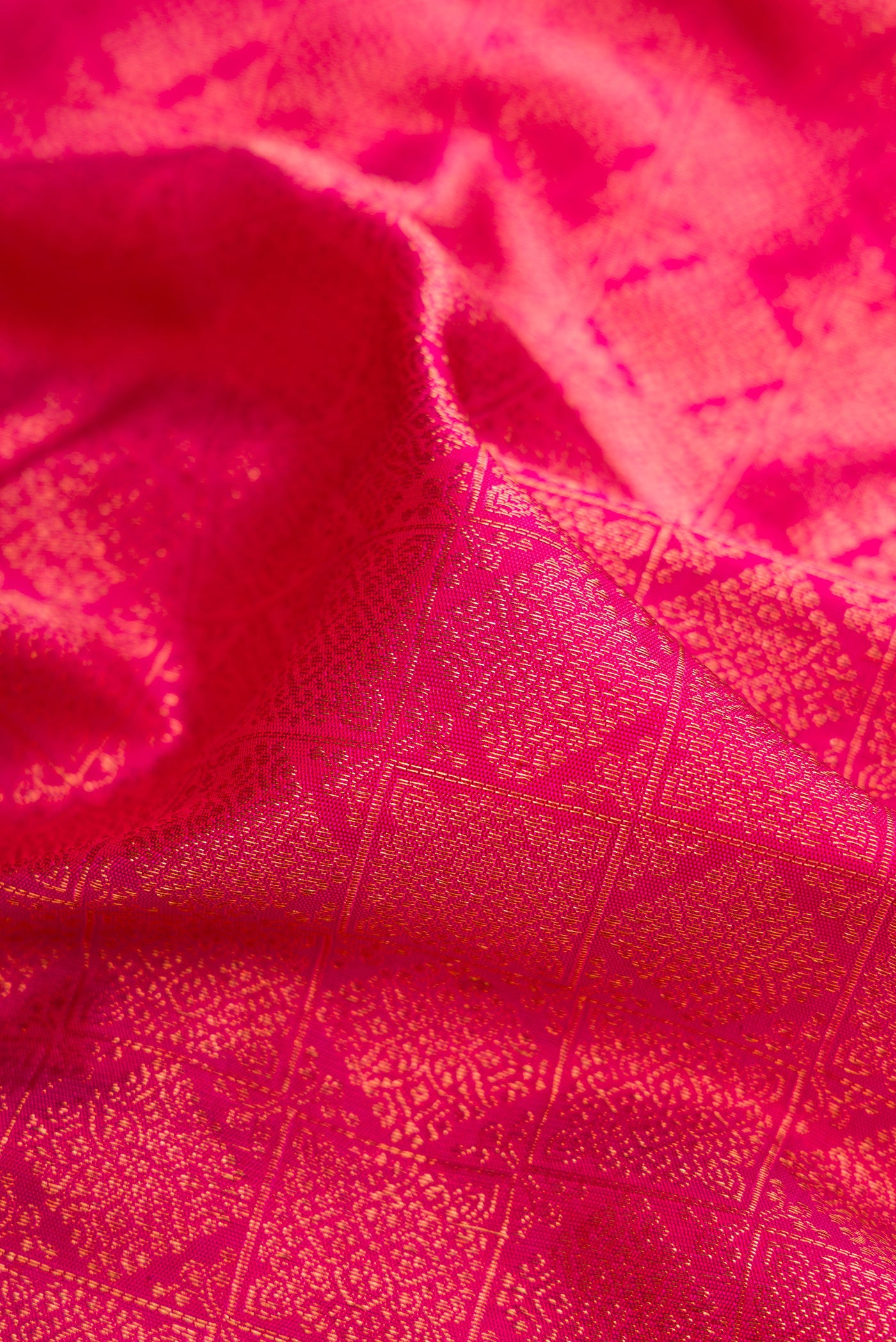 Close up of Pink Dual Tone Kanjivaram Silk Saree with Zari Brocade on the body and Zari Border.  displaying folds