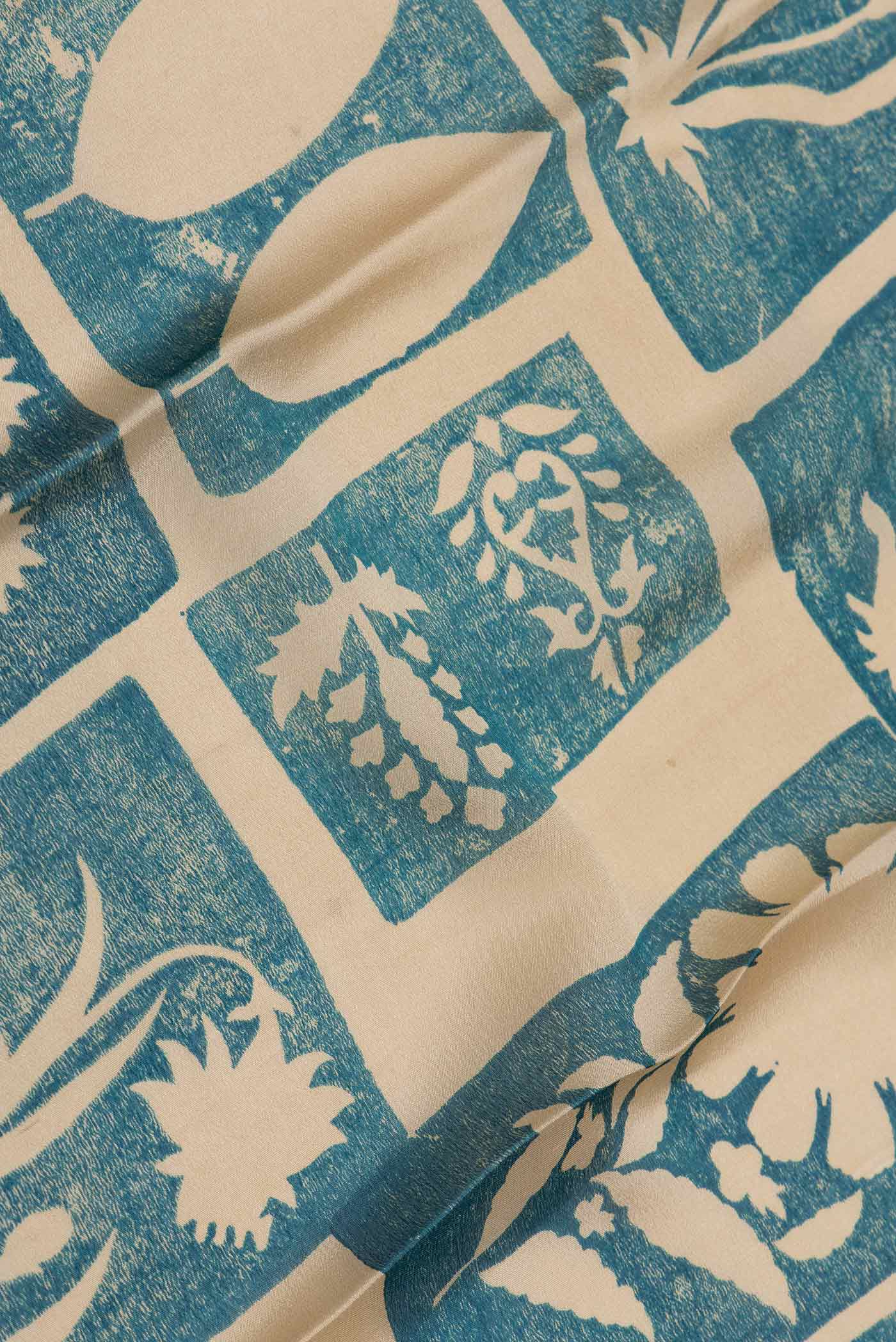 Close up of Green Dual Tone Mysore Crepe Saree with Printed design on the body and Zari Border displaying folds