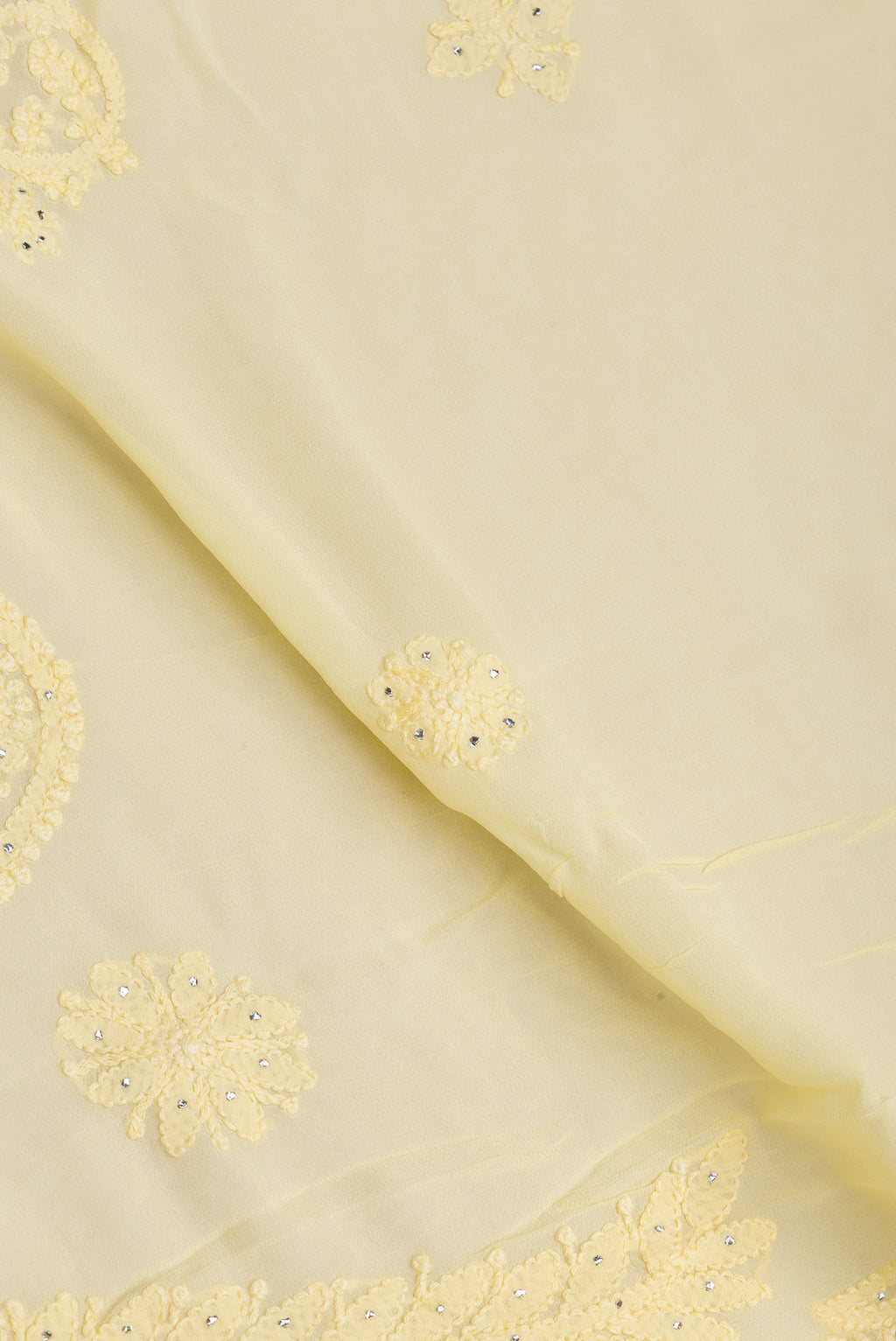 Close up of Yellow Georgette Saree with Embroidery on the body and Embroidery Border.  displaying folds