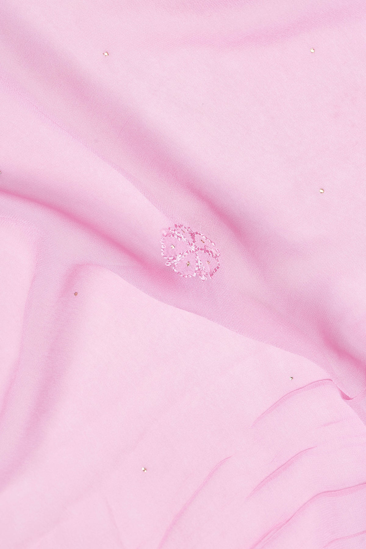 Close up of Pink Dual Tone Georgette Saree with Embroidery on the body and Embroidery Border.  displaying folds