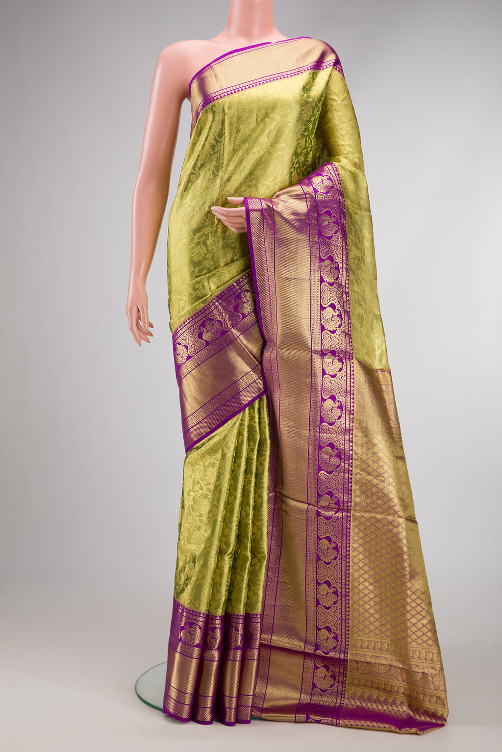 Green Dual Tone Kanjivaram Tissue Silk Saree with Zari Brocade on the body and Zari Border.  displayed on a mannequin