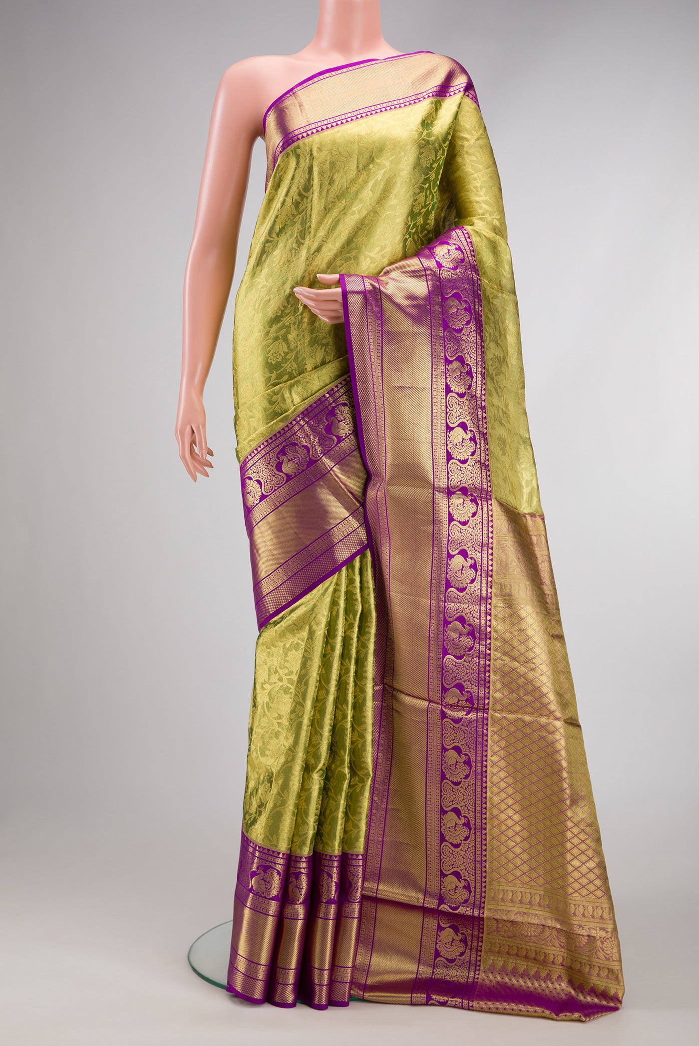 Green Dual Tone Kanjivaram Tissue Silk Saree with Zari Brocade on the body and Zari Border.  displayed on a mannequin
