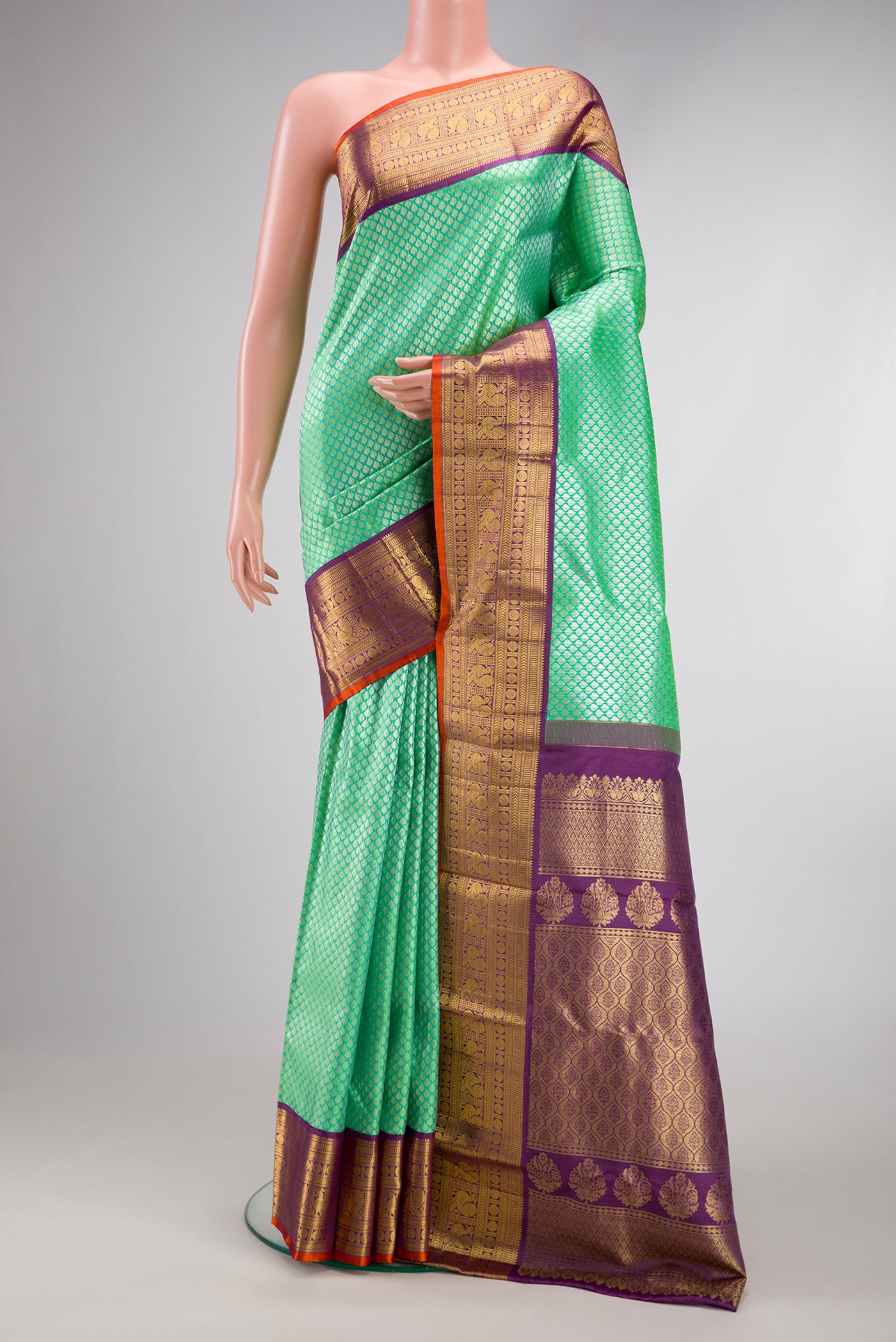 Sea Green Dual Tone Kanchipuram Silk Saree with Zari Brocade on the body and Zari Border.  displayed on a mannequin