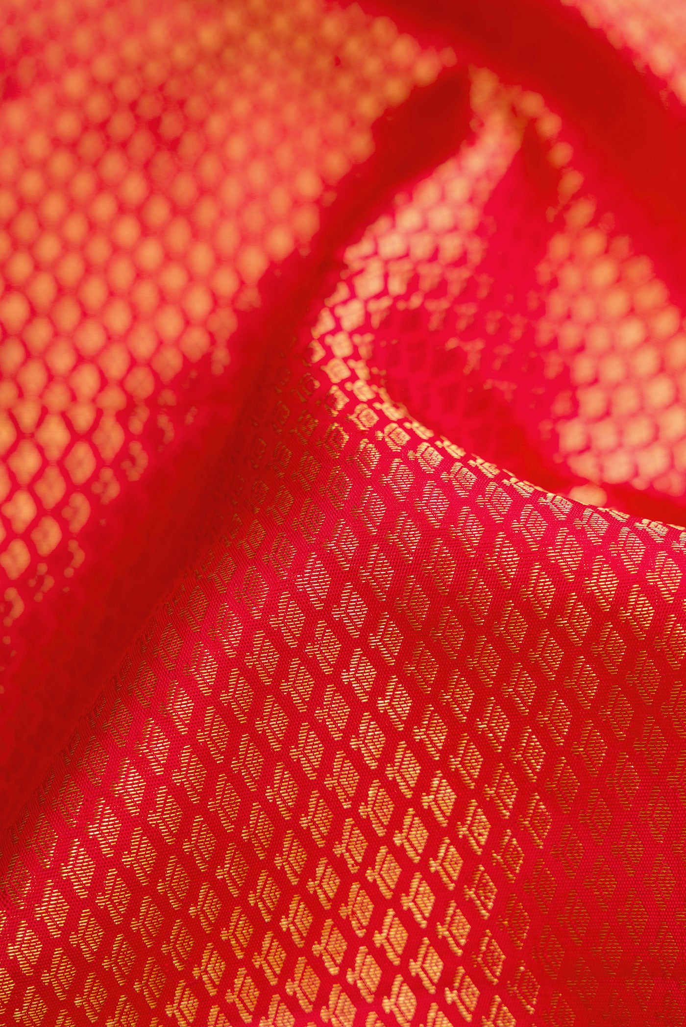 Close up of Red Dual Tone Kanchipuram Silk Saree with Zari Brocade on the body and Zari Border.  displaying folds