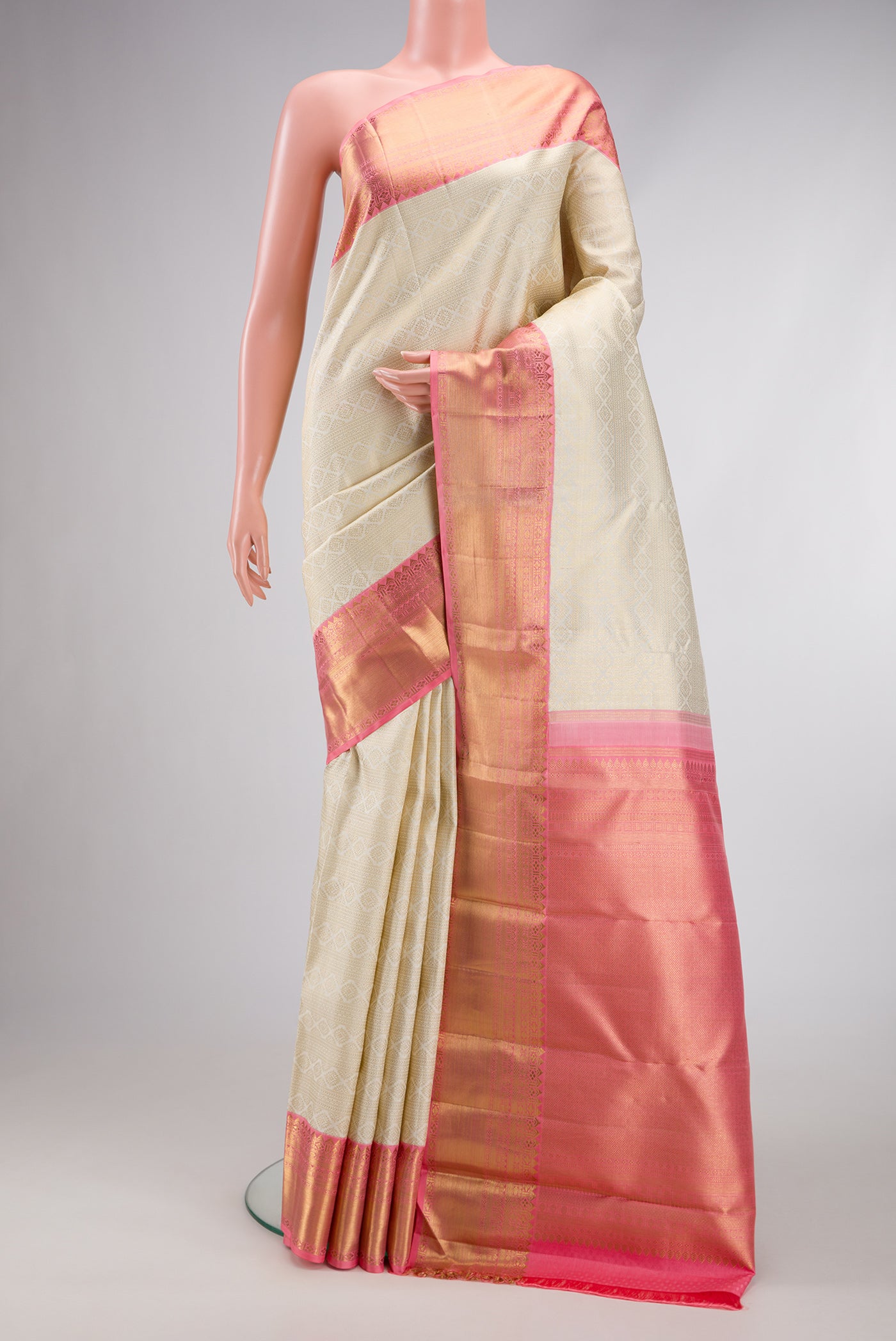 Pure Silk Pure Zari Off White Dual Tone Kanjivaram Saree with Zari Brocade on the body and Zari Border.  displayed on a mannequin