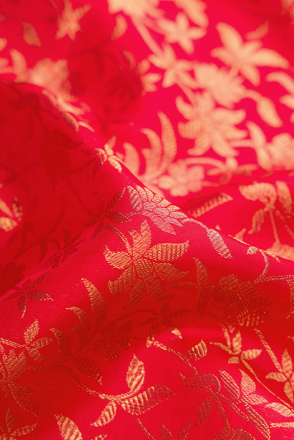 Close up of Pure Silk Pure Zari Red Dual Tone Kanjivaram Saree with Zari Brocade on the body and Zari Border.  displaying folds