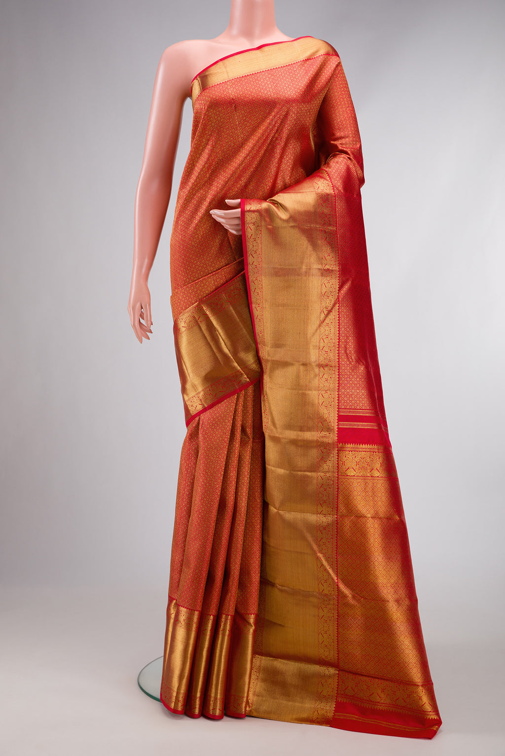 Pure Silk Pure Zari Red Dual Tone Kanjivaram Saree with Zari Brocade on the body and Zari Border.  displayed on a mannequin