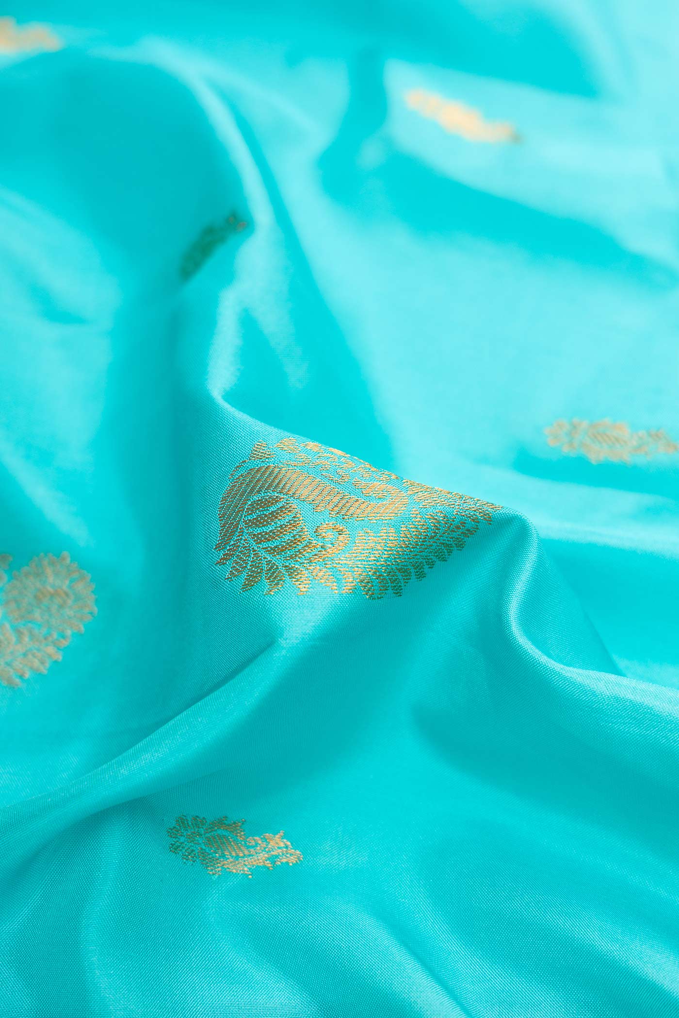 Close up of Sky Blue Dual Tone Gadwal Silk Saree with Zari Butta on the body and Zari Border displaying folds