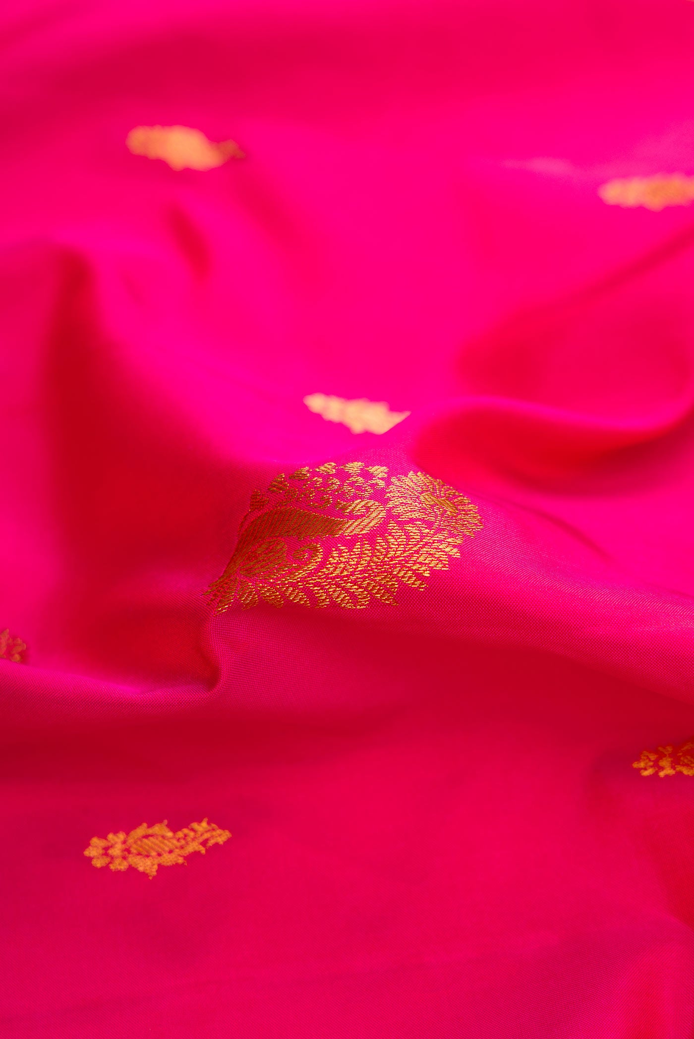 Close up of Dark Pink Dual Tone Gadwal Silk Saree with Zari Butta on the body and Zari Border displaying folds