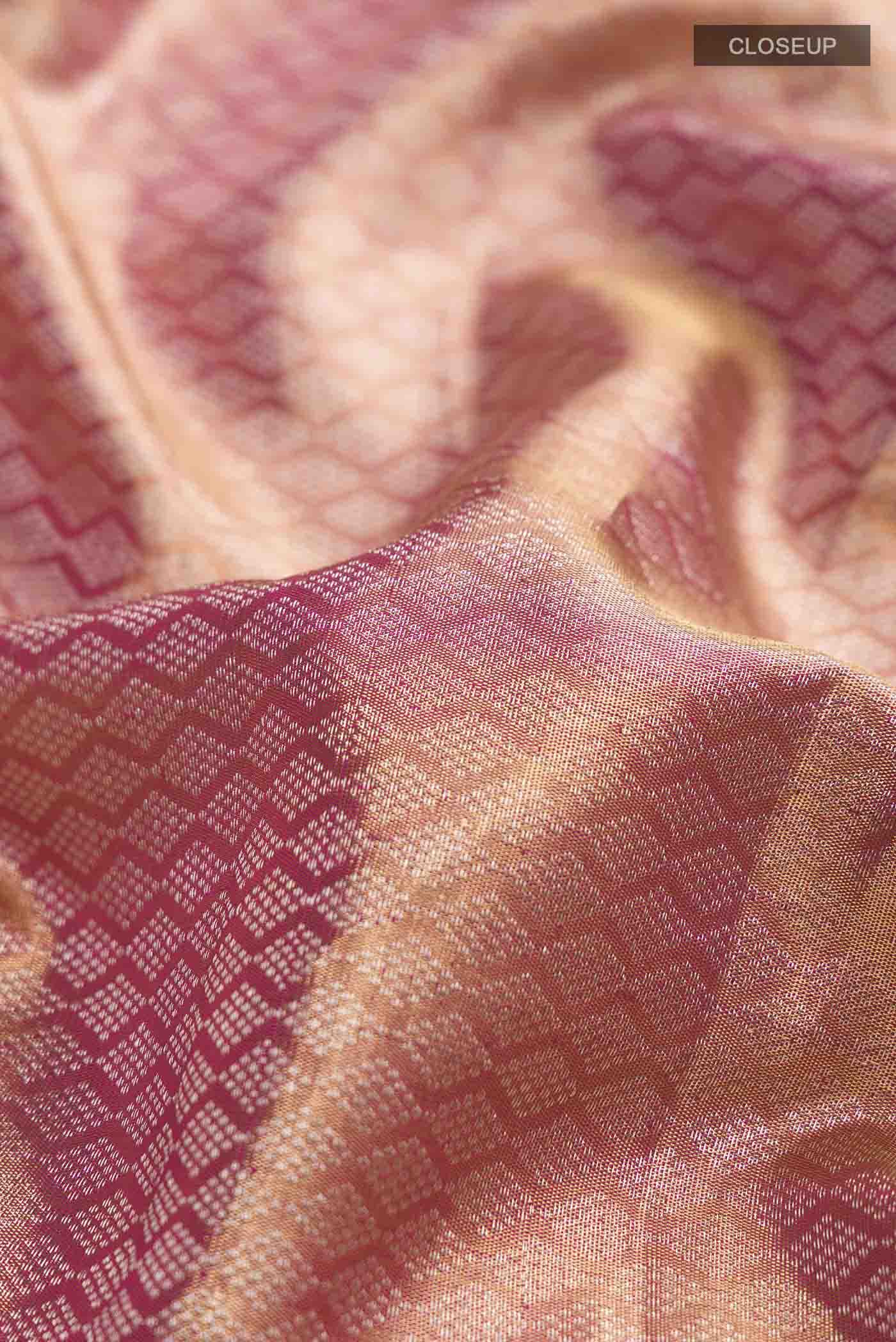 Close up of Pink with Gold Color Kanchipuram Tissue Silk Saree with Zari Brocade on the body and Zari Border displaying folds