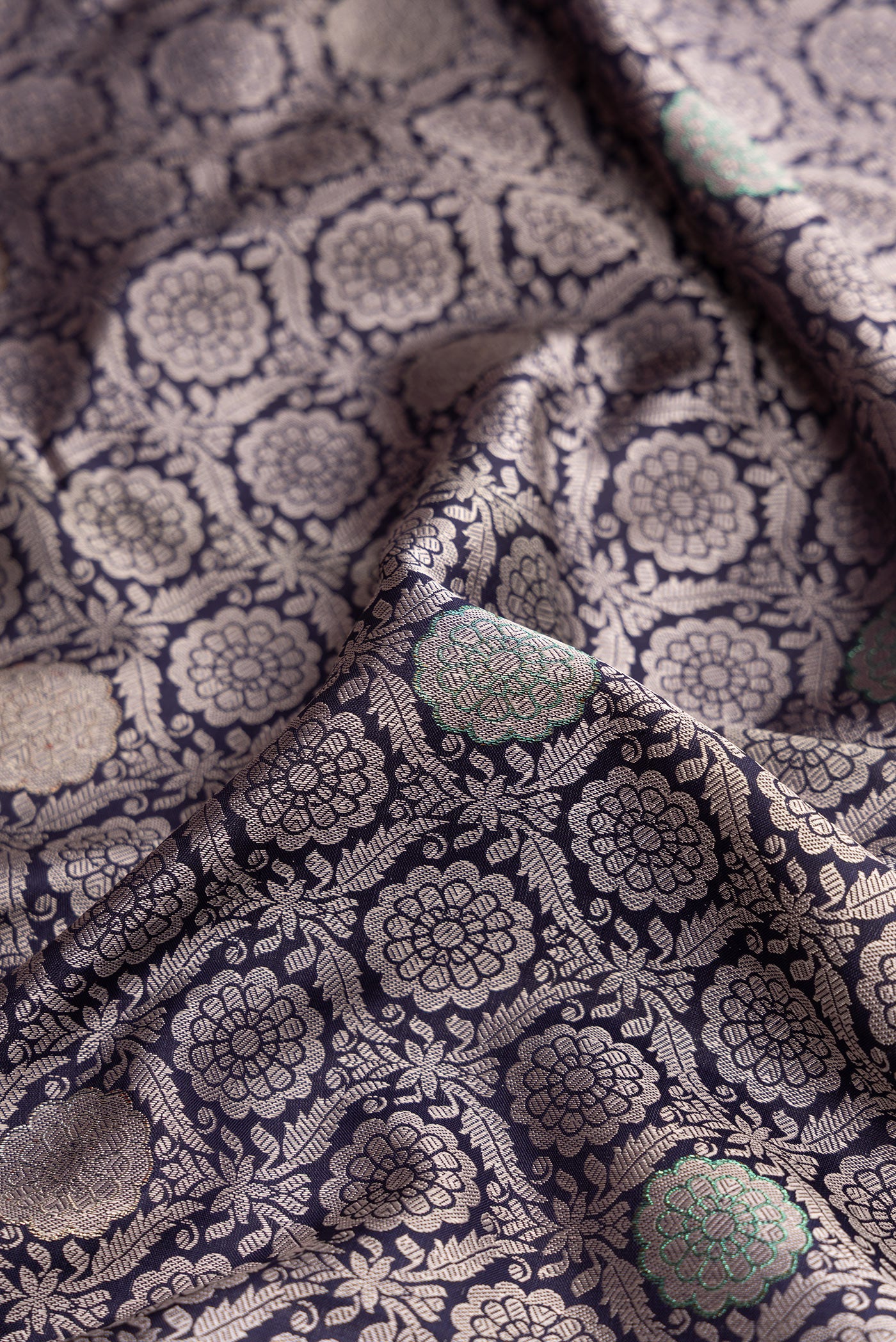 Close up of Navy Blue Kanjivaram Silk Saree with Jacquard With Zari Butta on the body and Zari Border.  displaying folds