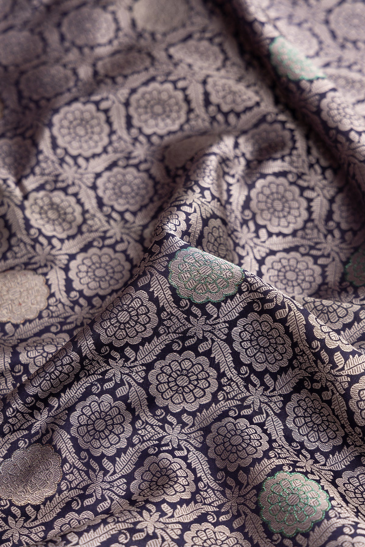 Close up of Navy Blue Kanjivaram Silk Saree with Jacquard With Zari Butta on the body and Zari Border.  displaying folds