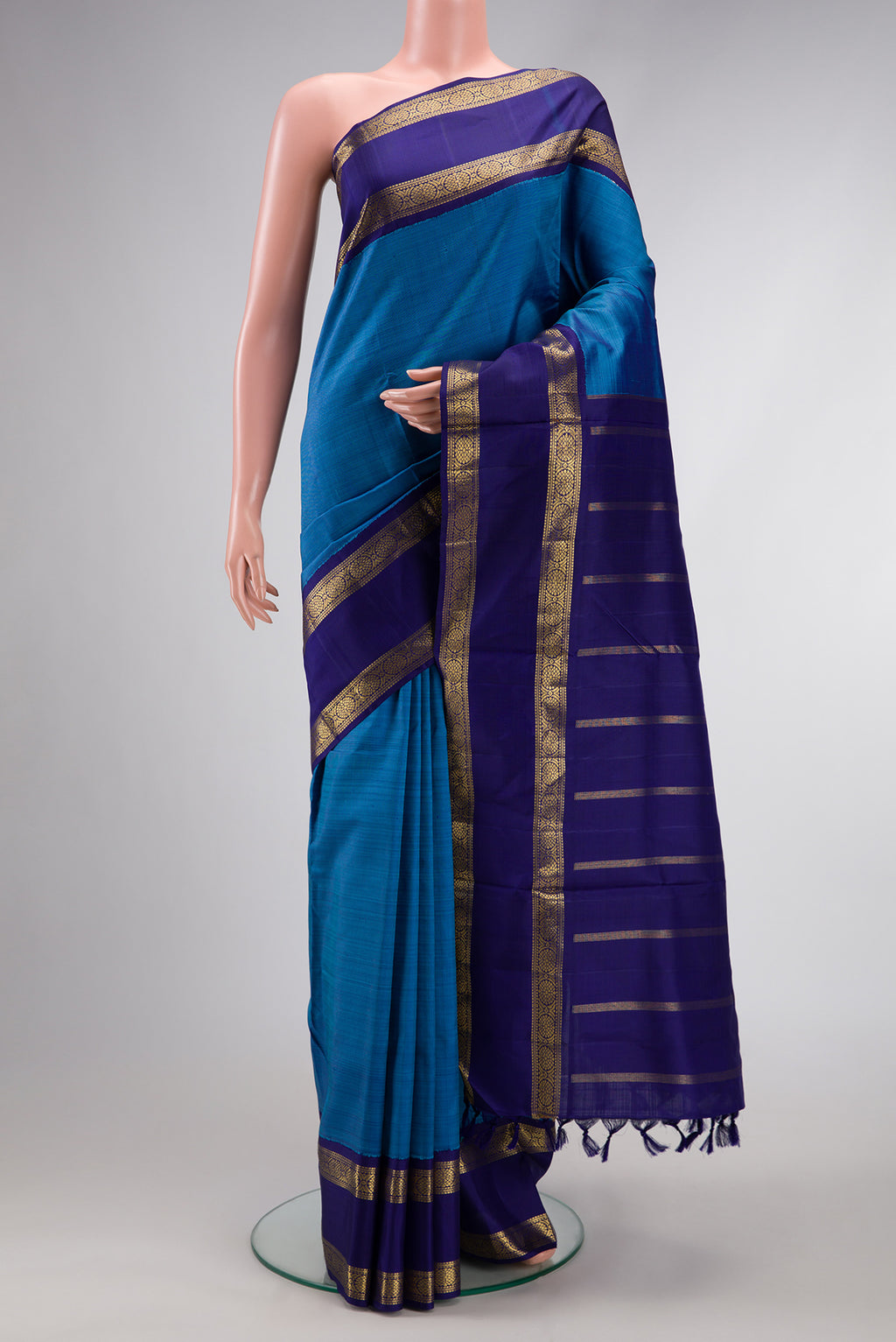 Pure Silk Pure Zari Peacock Blue Dual Tone Kanchipuram Nine Yards Saree with Plain Body and Zari Border.  displayed on a mannequin