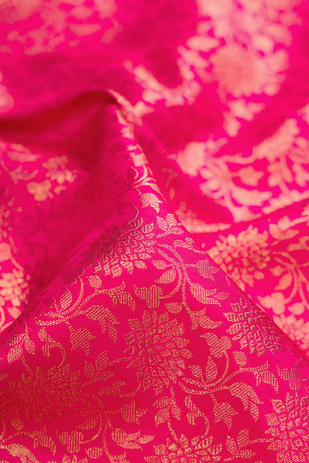 Close up of Pure Silk Pure Zari Dark Pink Dual Tone Kanjivaram Saree with Zari Brocade on the body and Zari Border.  displaying folds