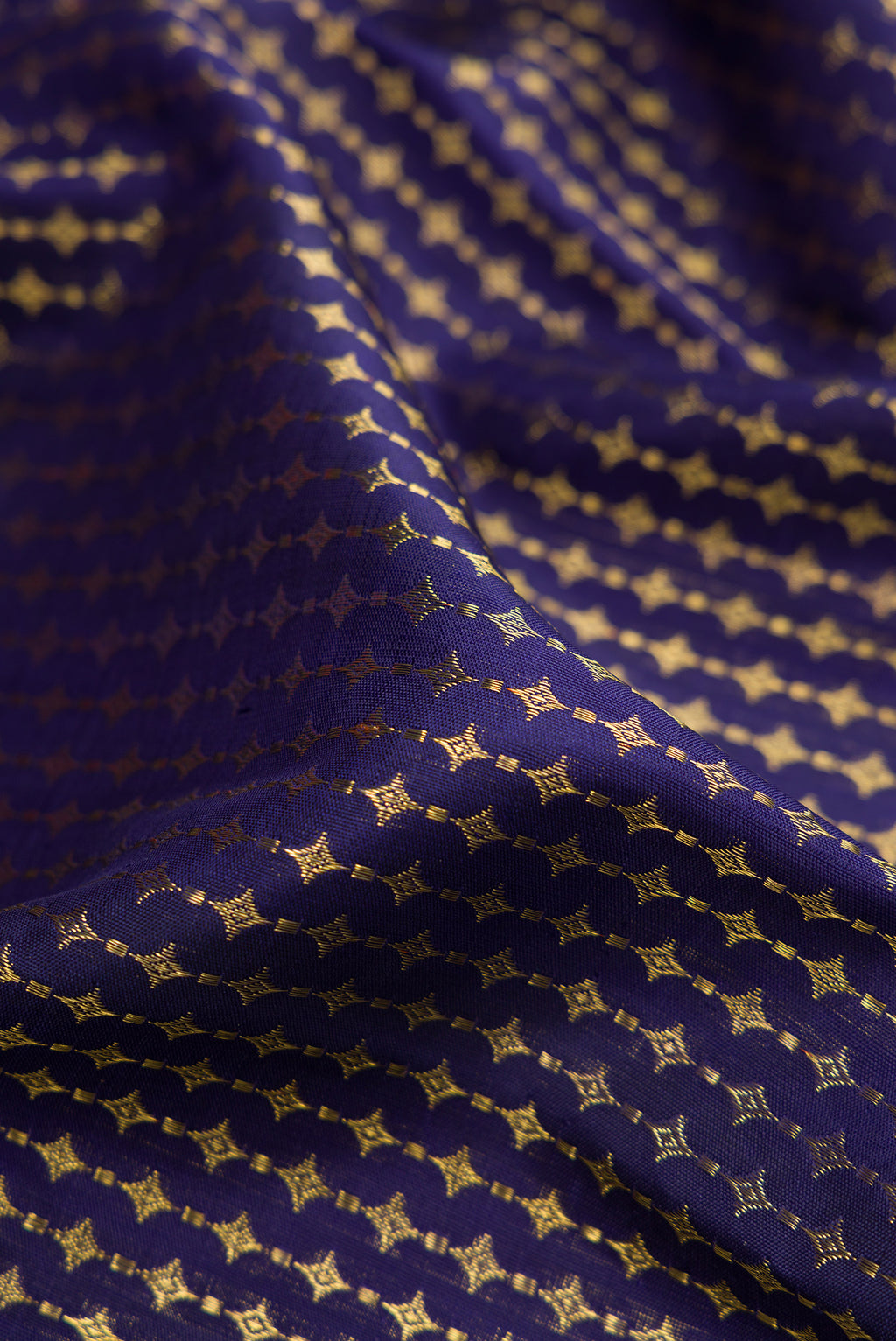 Close up of Pure Silk Pure Zari Navy Blue Kanjivaram Saree with Zari Brocade on the body and Zari Border.  displaying folds