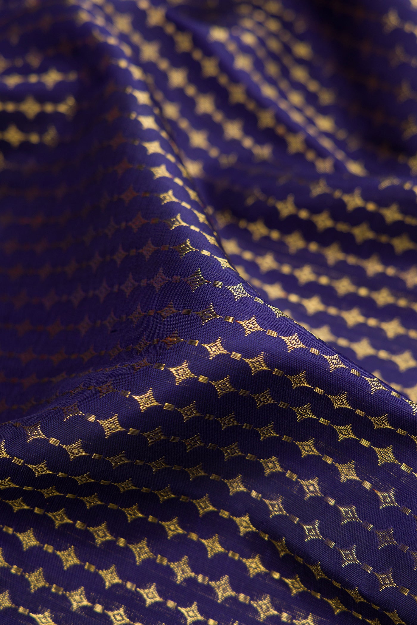 Close up of Pure Silk Pure Zari Navy Blue Kanjivaram Saree with Zari Brocade on the body and Zari Border.  displaying folds