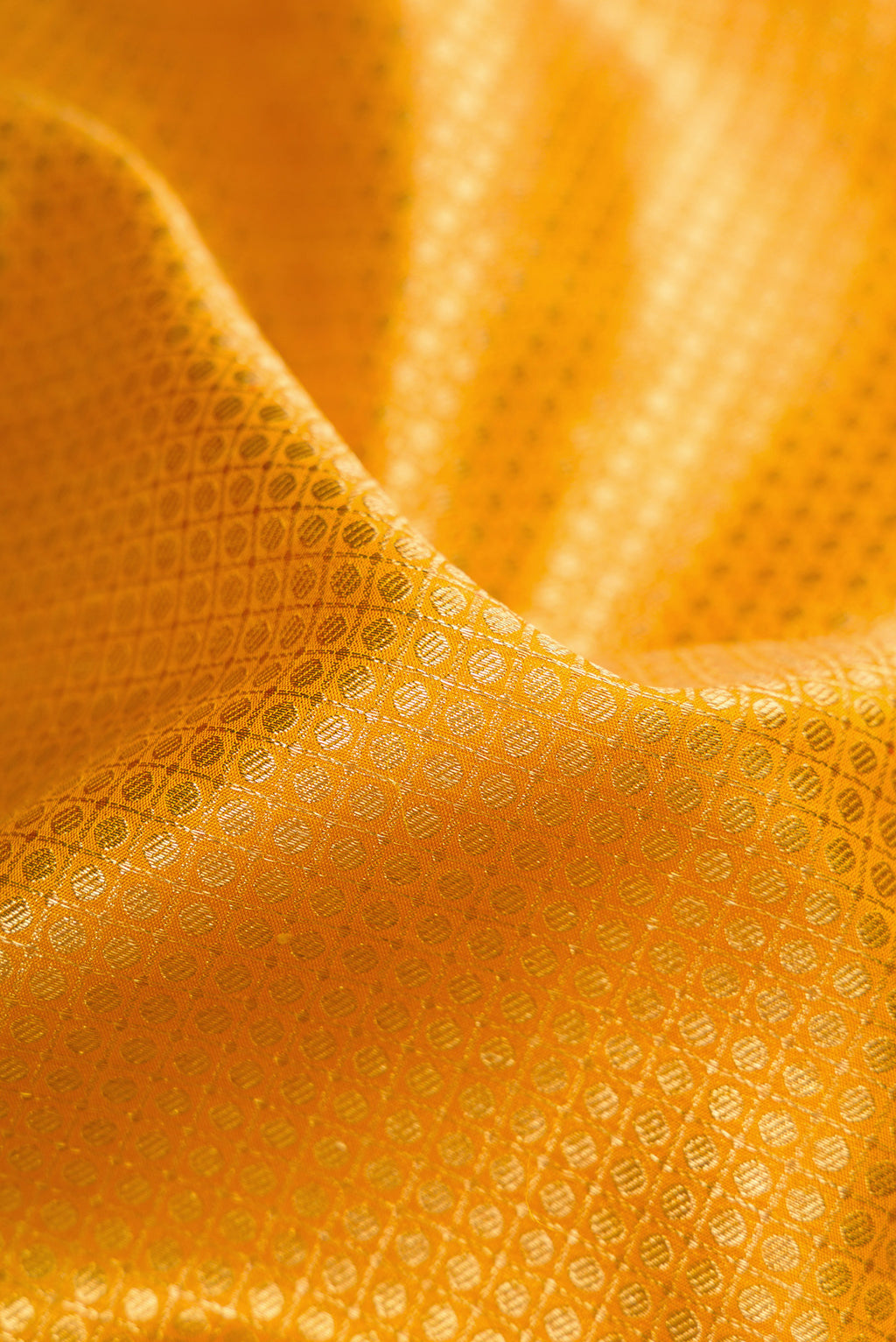 Close up of Pure Silk Pure Zari Yellow Dual Tone Kanjivaram Saree with Zari Brocade on the body and Zari Border.  displaying folds