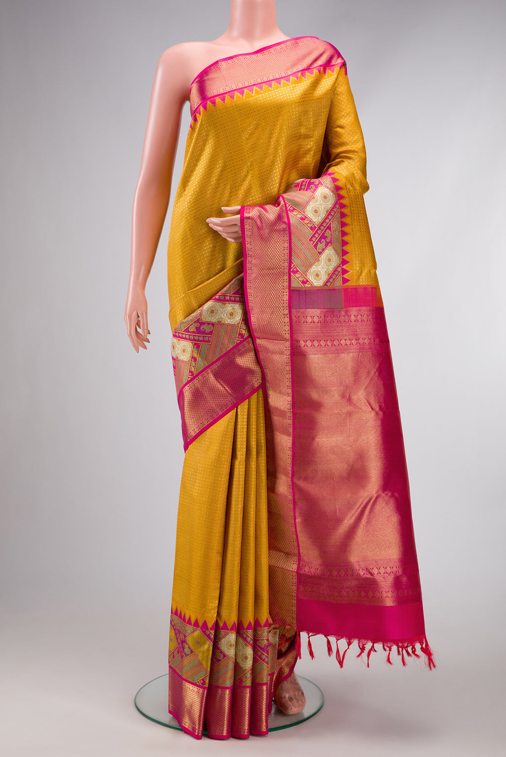 Pure Silk Pure Zari Yellow Dual Tone Kanjivaram Saree with Zari Brocade on the body and Zari Border.  displayed on a mannequin