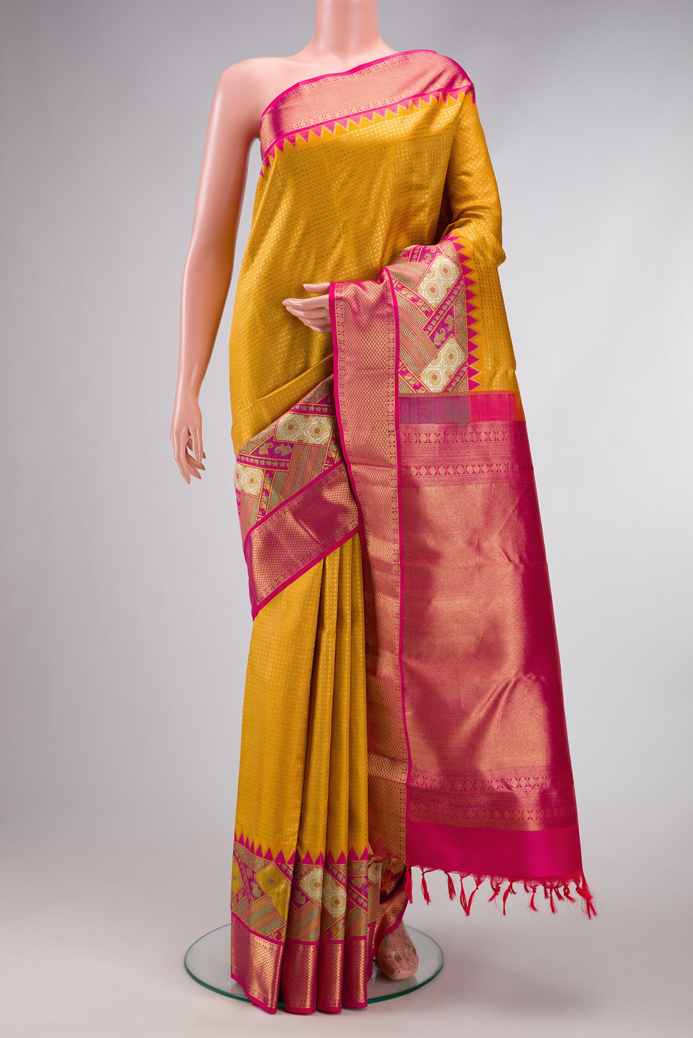 Pure Silk Pure Zari Yellow Dual Tone Kanjivaram Saree with Zari Brocade on the body and Zari Border.  displayed on a mannequin