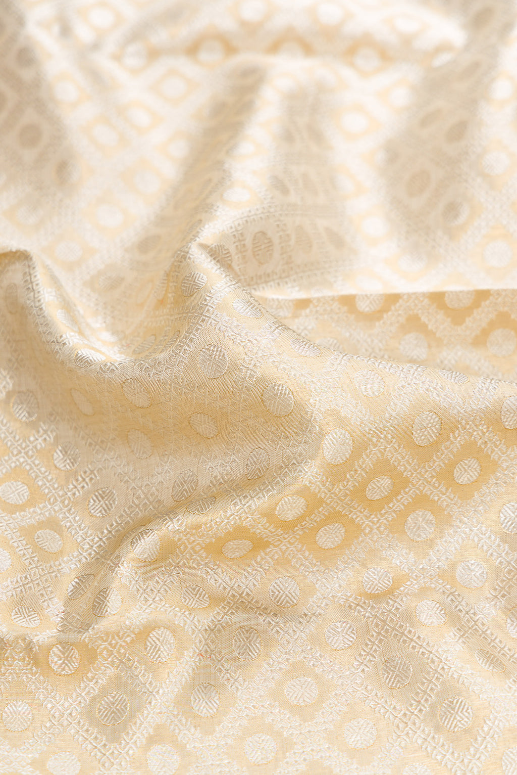 Close up of Gold Dual Tone Kanjivaram Tissue Silk Saree with Zari Brocade on the body and Zari Border.  displaying folds