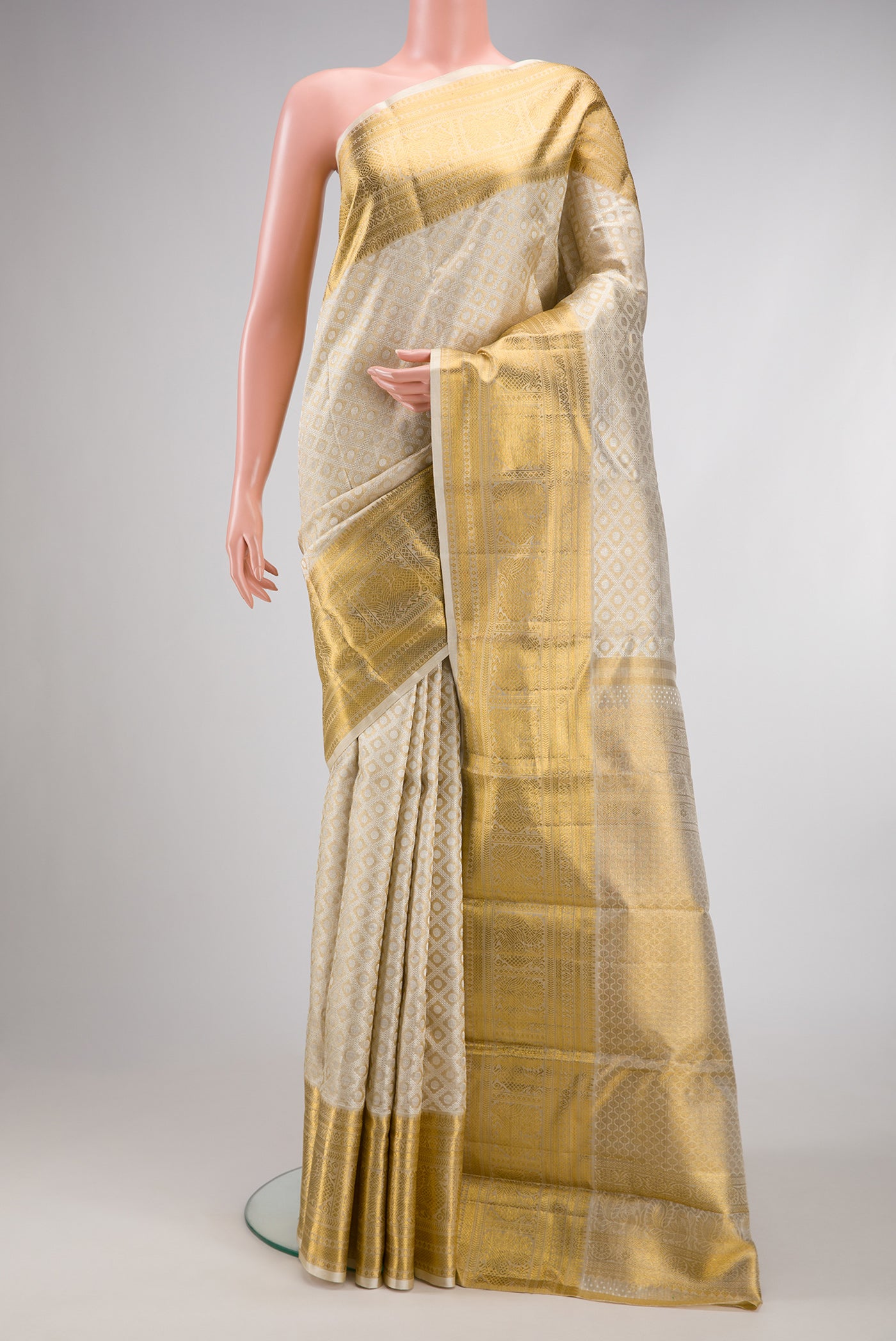 Gold Dual Tone Kanjivaram Tissue Silk Saree with Zari Brocade on the body and Zari Border.  displayed on a mannequin