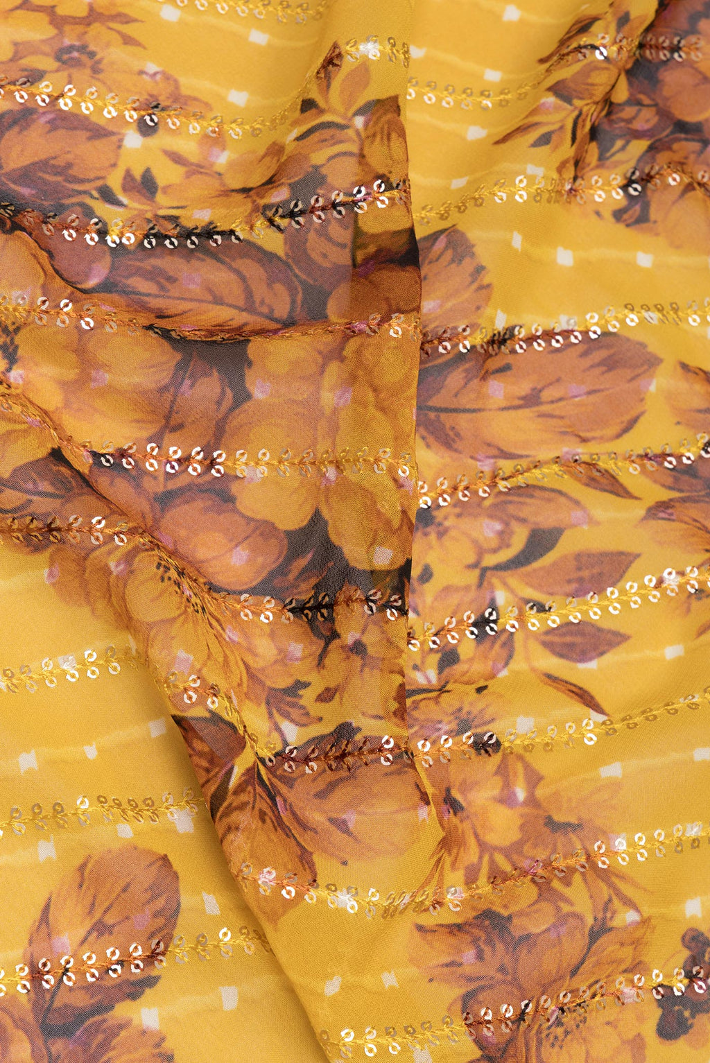 Close up of Mustard Georgette Saree with Embroidery on the body and Sequin Border.  displaying folds