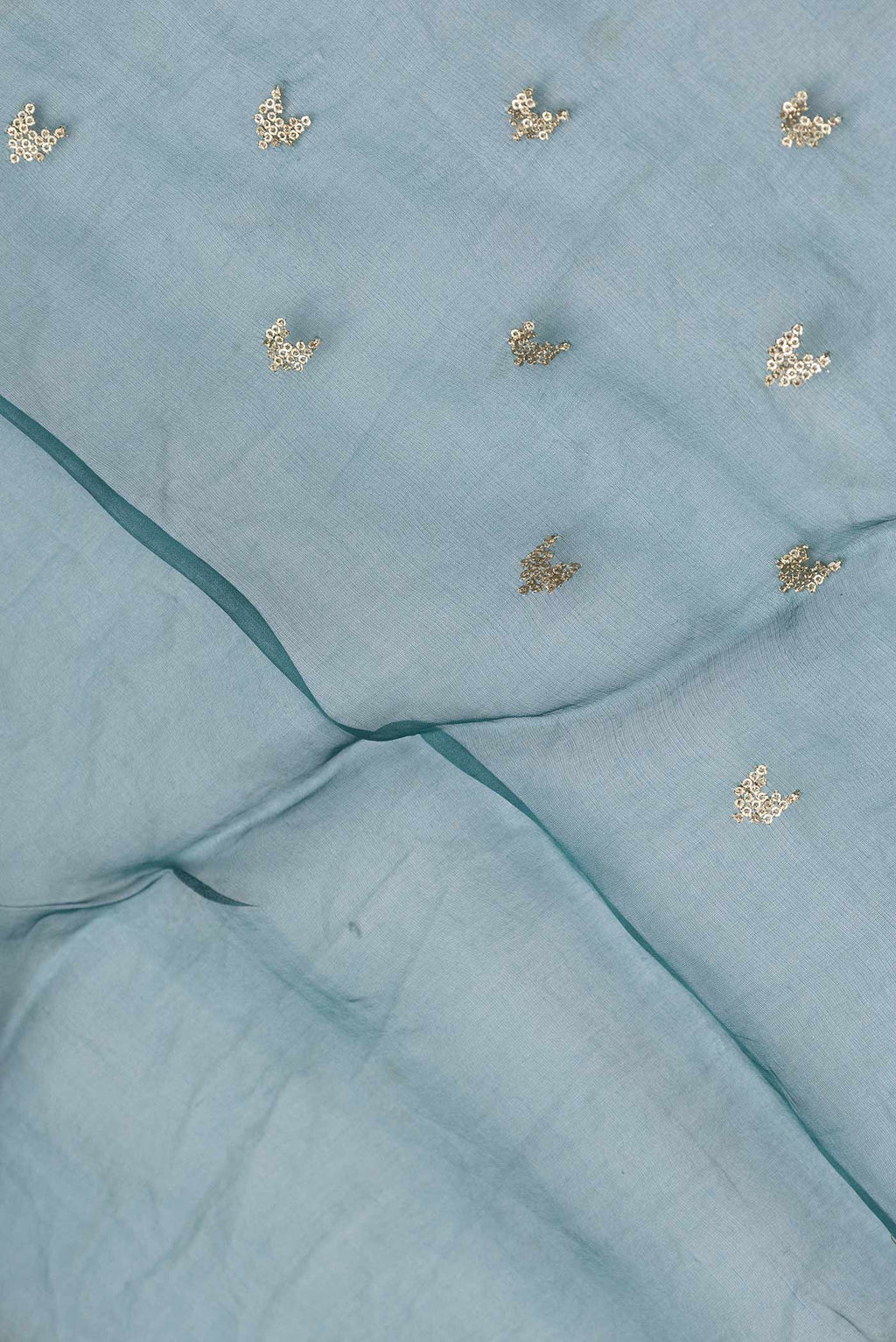 Close up of Grey Dual Tone Organza Silk Saree with Zari Butta on the body and Zari Border.  displaying folds