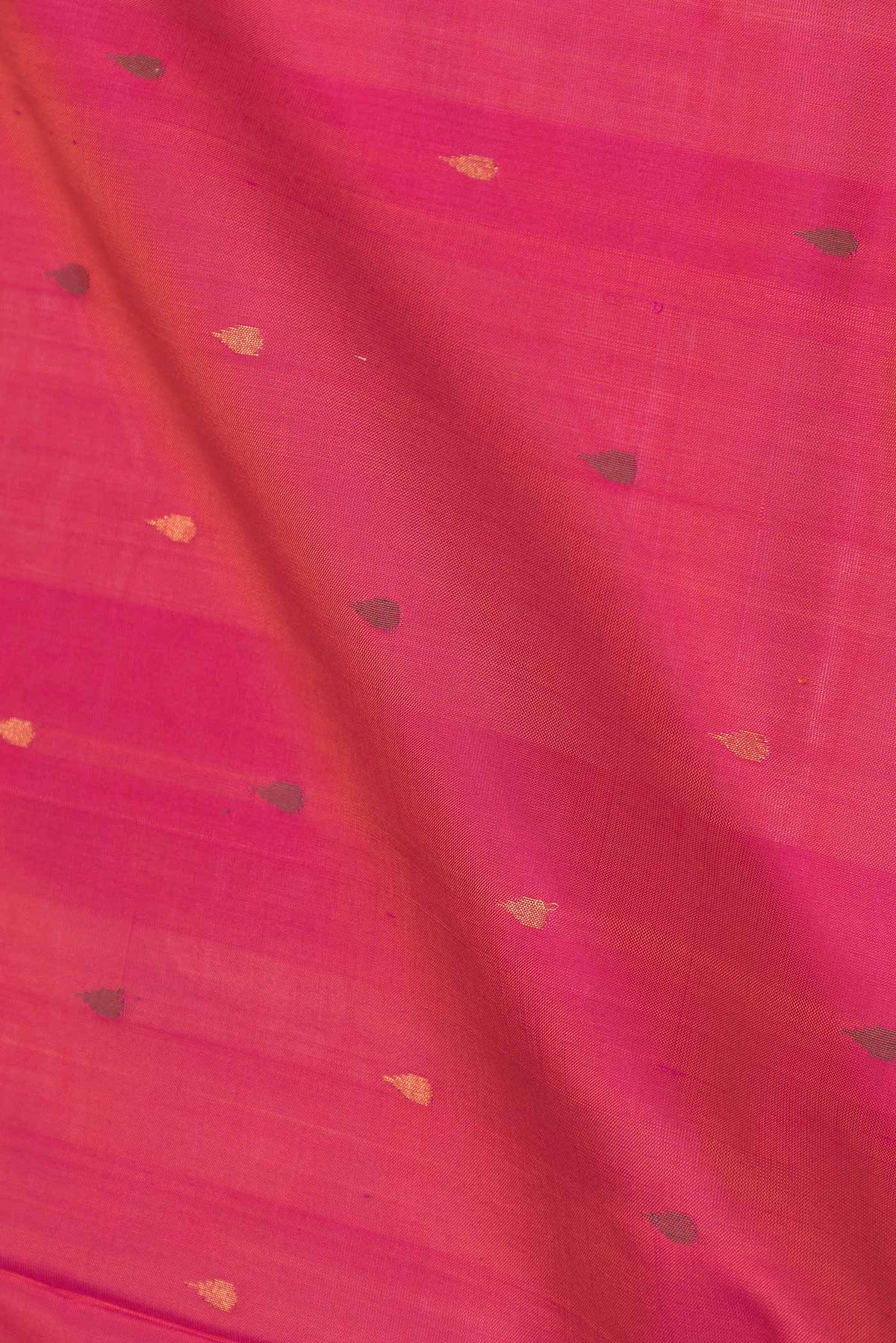 Close up of Pink Uppada Silk Saree with Zari And Thread Butta on the body and Zari Border displaying folds