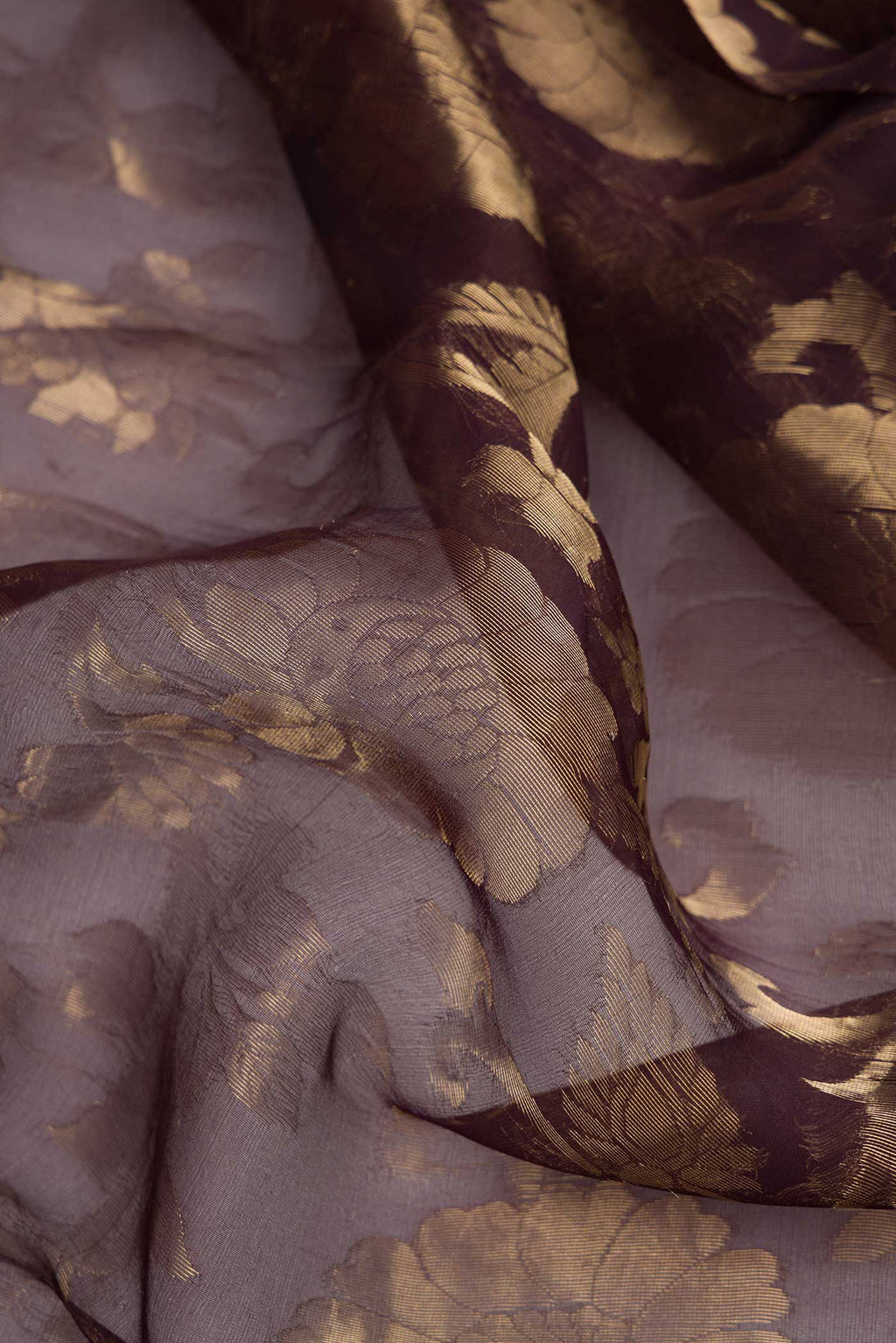 Close up of Coffee Brown Dual Tone Organza Silk Saree with Zari Brocade on the body and Zari Border.  displaying folds